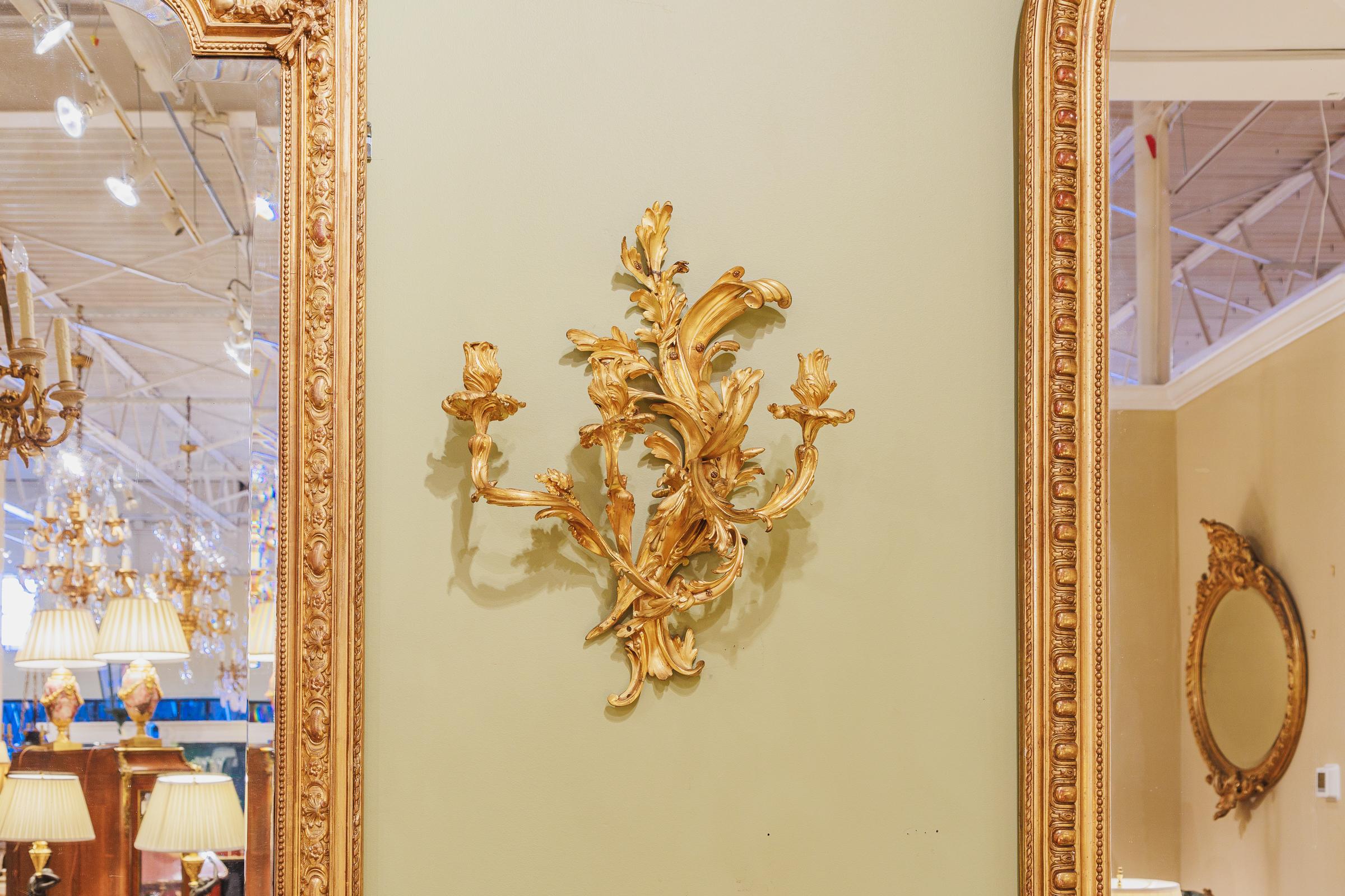 A fine pair of French 19th century Louis XV fire gilt three light sconces. Large and very fine details.