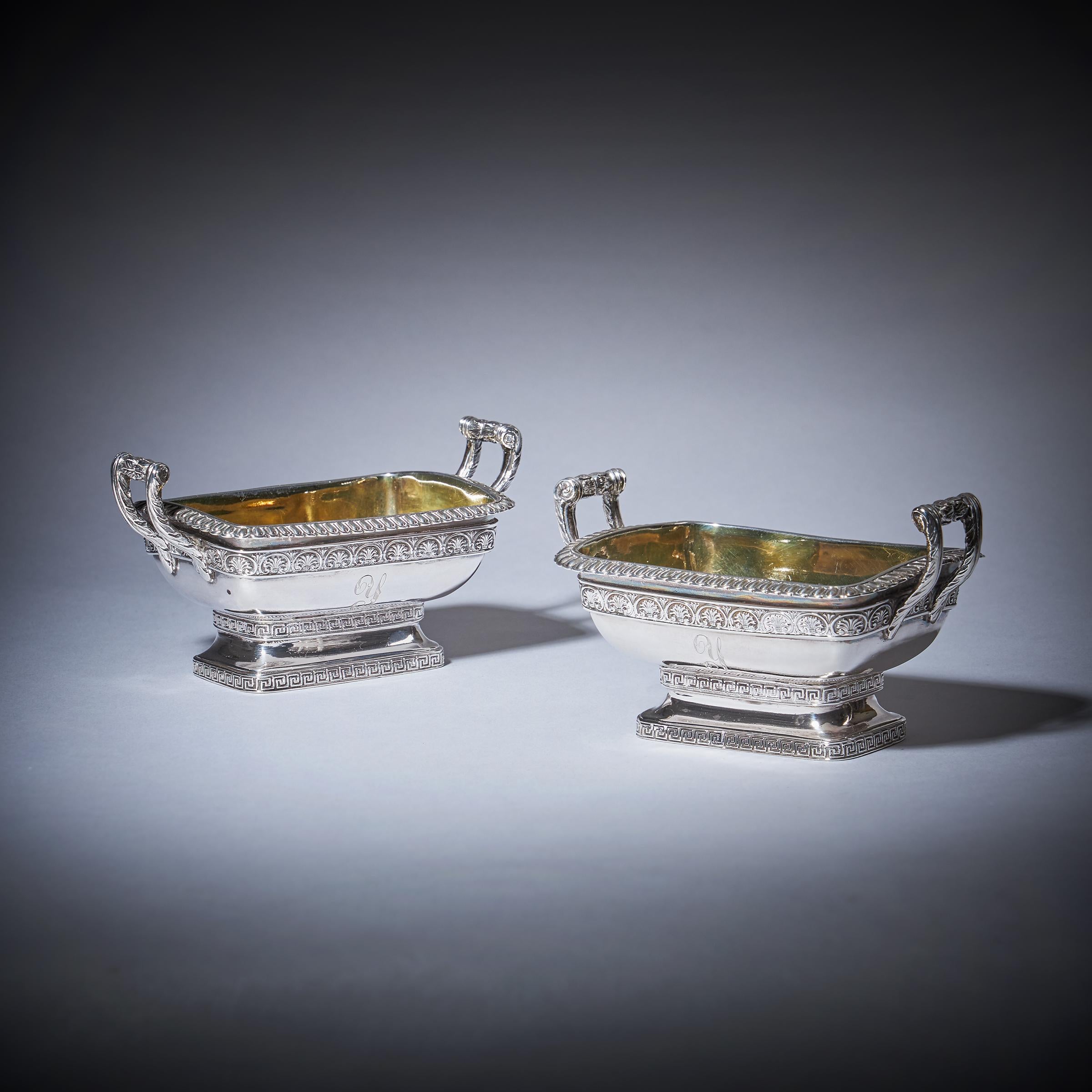 A Fine Pair of Twin Handled George III Grand Tour Influenced Silver-Gilt Salts of Bath Form by William Fountain, London 1808.

Each lined in gilt and finely tooled with leaf clasp scroll handles and a fluted border. Embossed to the frieze in an