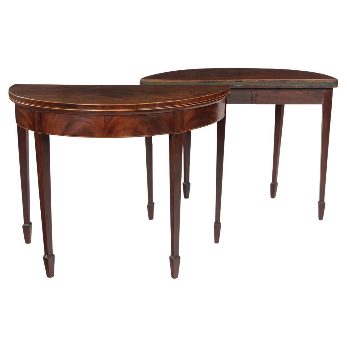 A fine pair of George III period mahogany demilune card tables with provenance