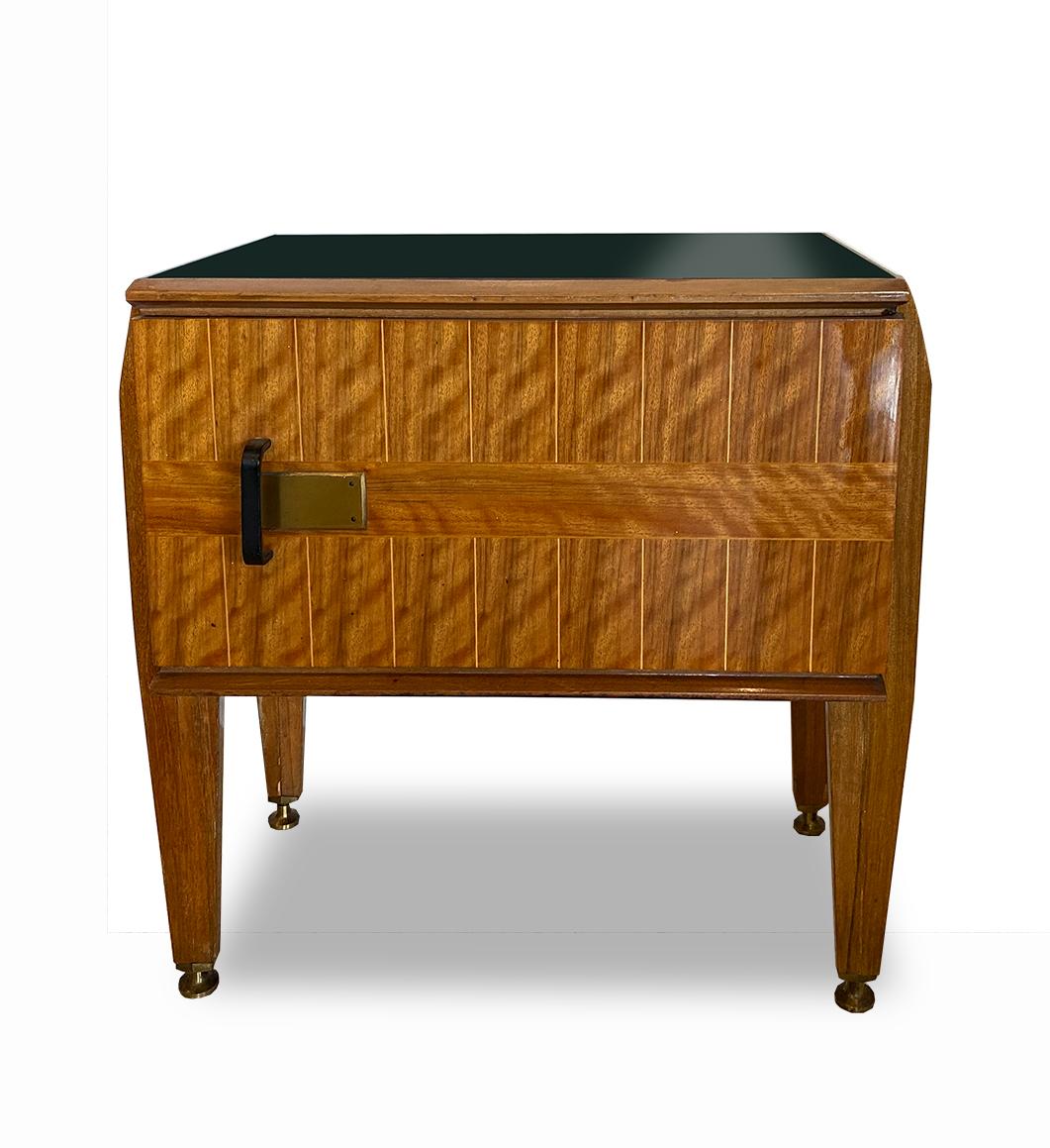 A rectangular pair of tables with glass inset top, above an inlaid cabinet of inlaid rare and burled woods. One door opens to reveal ample storage space. The cabinet sits upon 4 tapered legs, terminating in bronze mounted feet. The front door has an