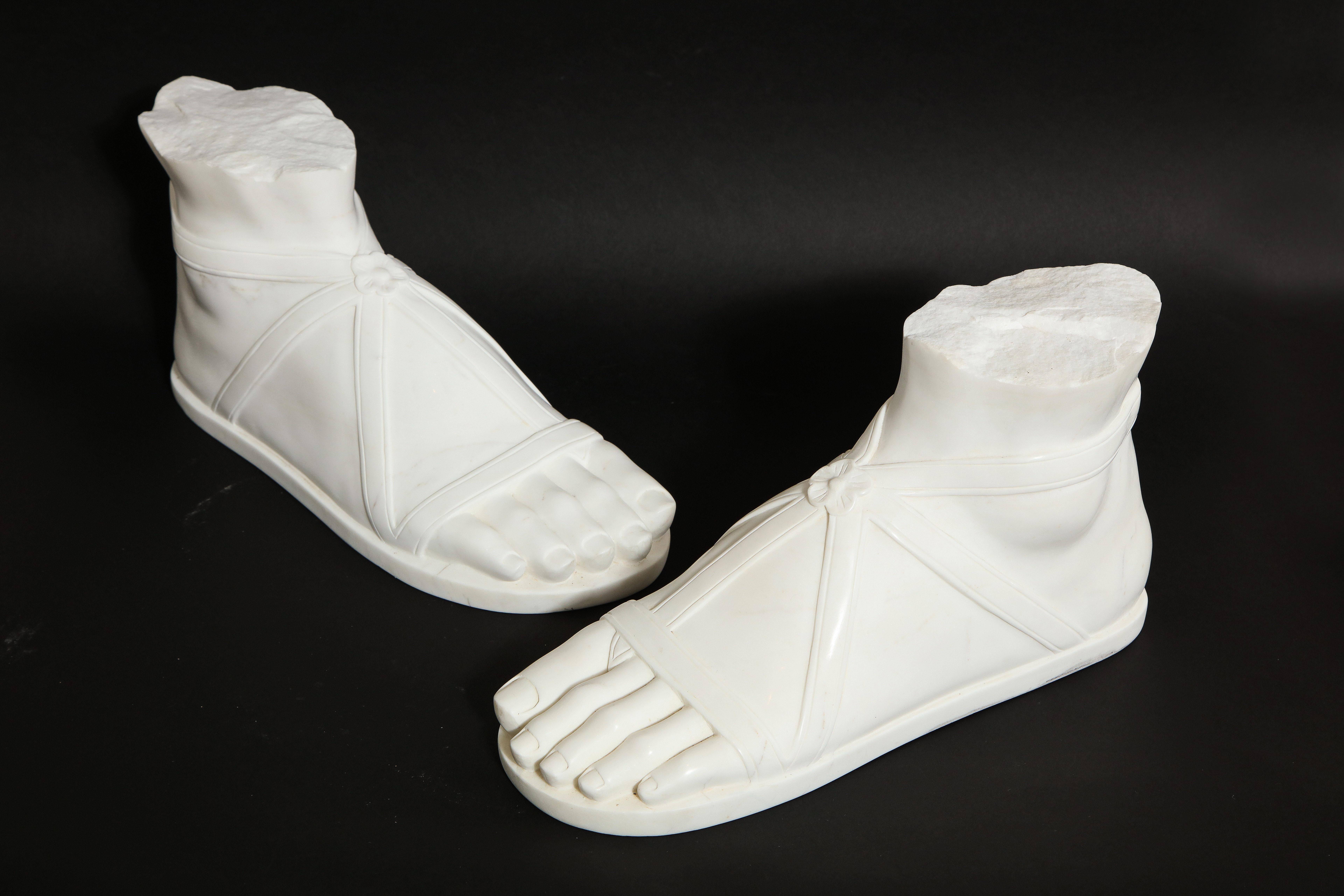 A fabulous and quite decorative, and large pair of Italian Roman Grand Tour Carrara marble feet. Each is exceptionally hand carved with meticulous detail and craftsmanship. They are exquisitely made to look as life-like as possible. Each foot is