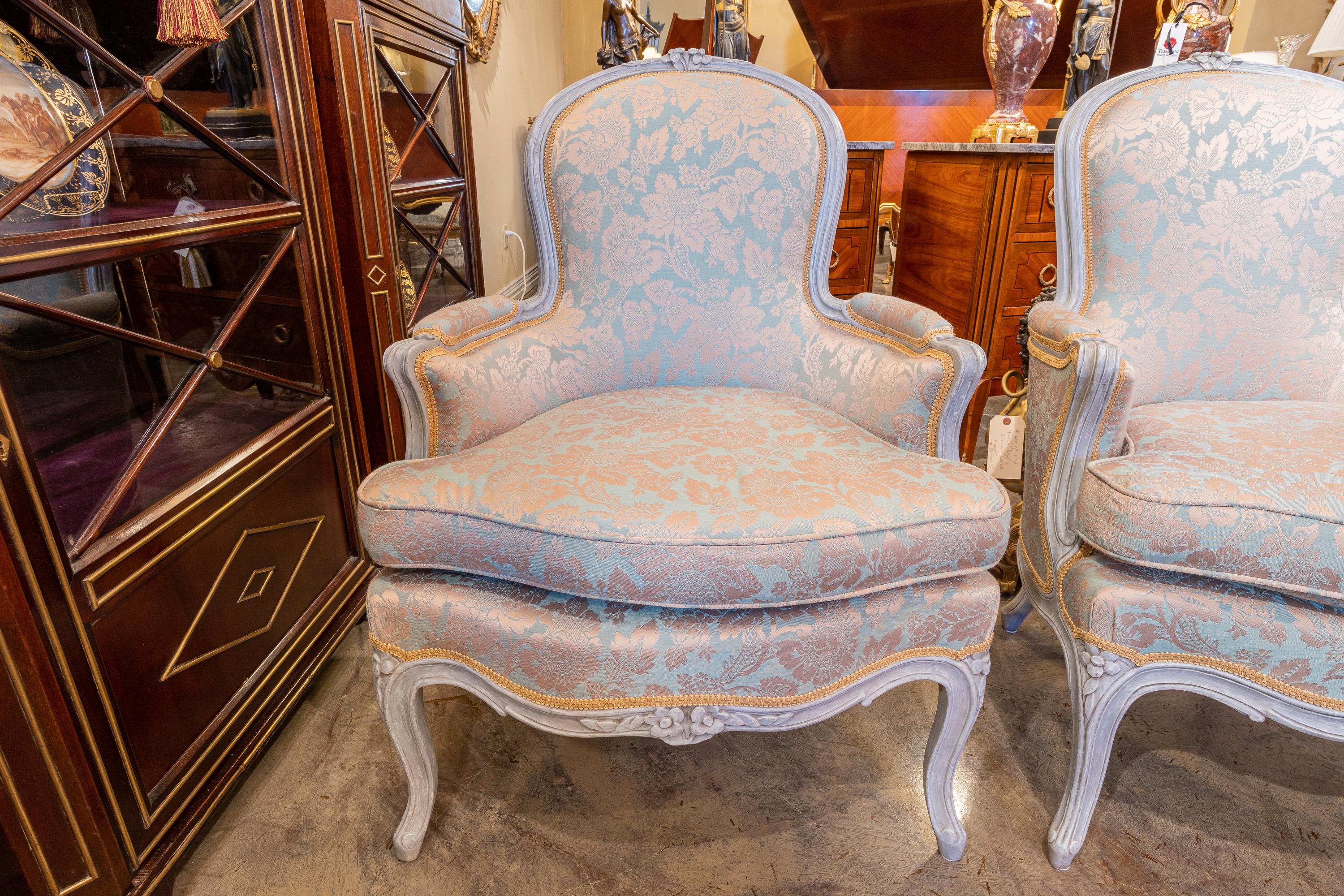 A fine pair of 18th century Louis XV period painted greyish blue bergeres. Covered in a damask.