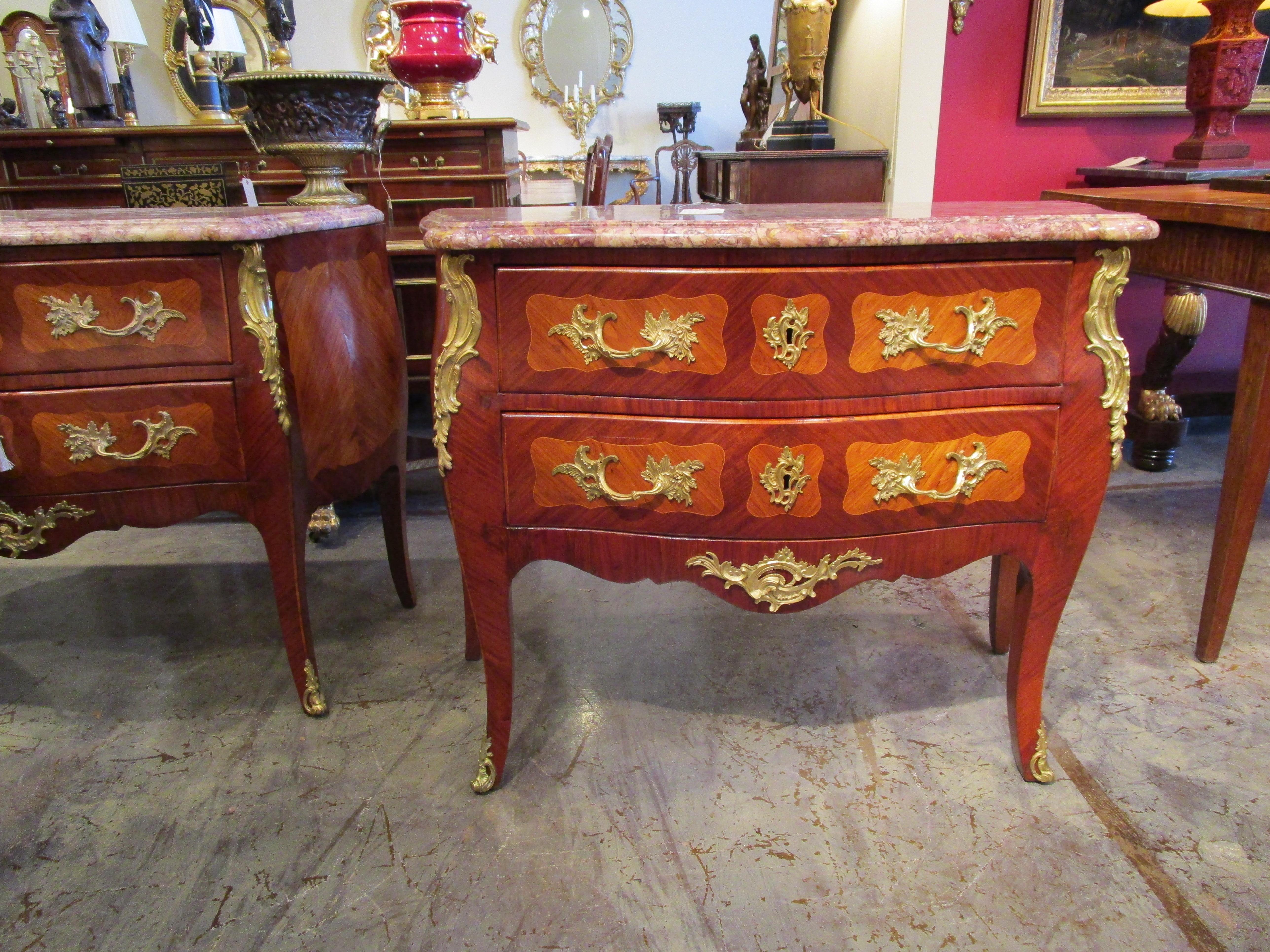 A fine pair of late 19th century French Louis XV kingwood and satinwood gilt bronze mounted commodes. Original breccia marble tops and fine gilt bronze mounts. Stamped illegibly CHARDO with a Fleur de lis in the center of the stamp. Possibly by