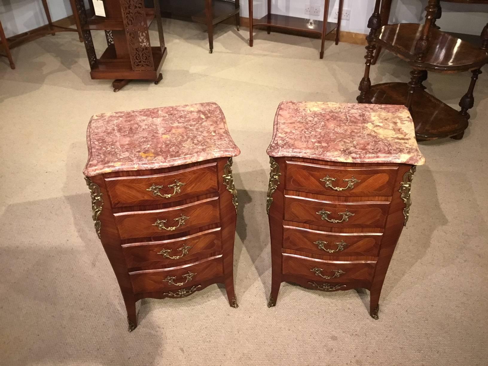 A fine pair of late 19th century French kingwood and ormolu-mounted bedside chests. Each having a shaped Spanish brocatelle serpentine shaped marble top above an arrangement of four oak lined drawers with kingwood veneered fronts and finely cast