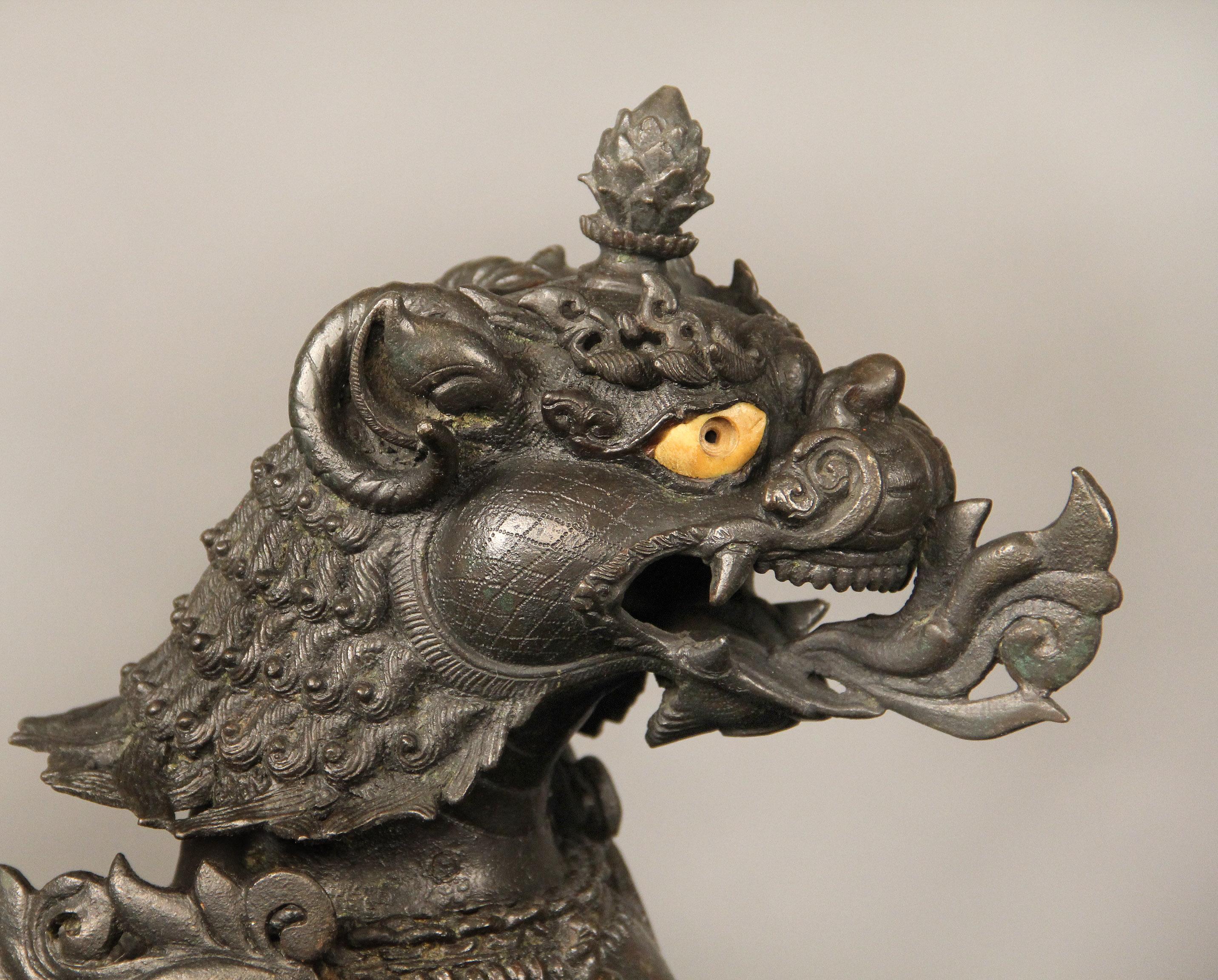 A fine quality pair of late 19th-early 20th century Chinese iron foo dog dragons.

Each dragon dressed in a helmet and full armour, breathing fire.