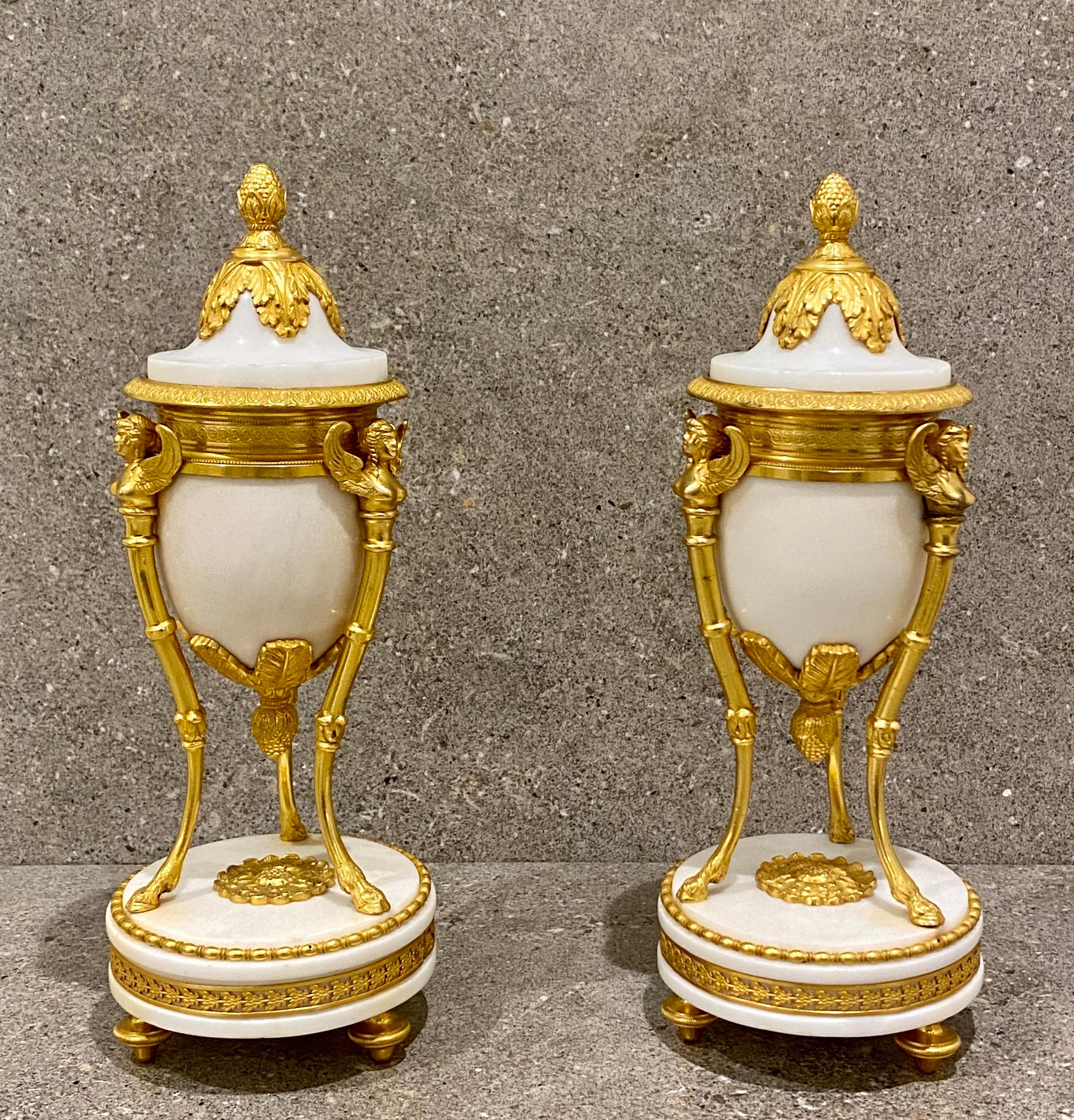 Rare Sphinx Cassolettes in white marble are very scarce and the best of this type. 
Each cassolette features three gilt bronze monopodia supports in the form of sphinxes. Each support is shaped like a winged female that stands on a single leg,