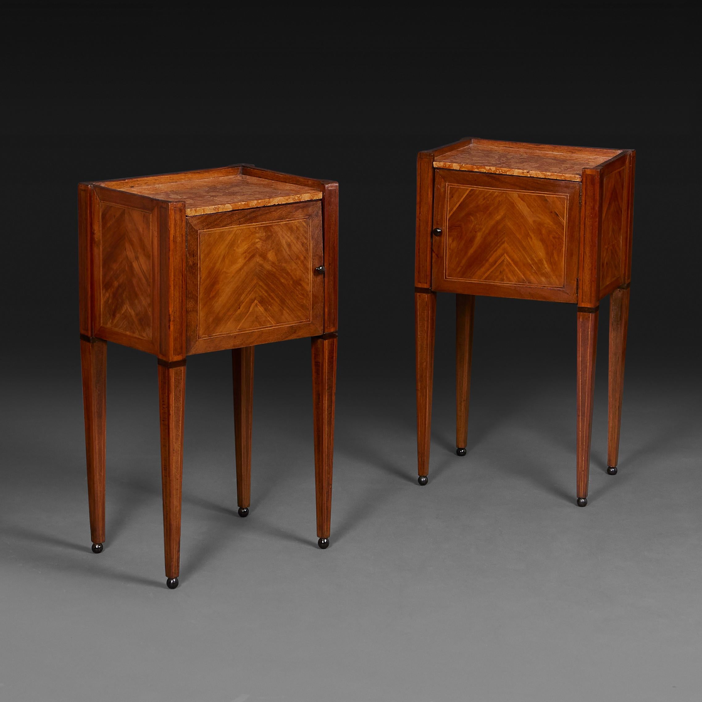 France, circa 1850

A fine pair of mid nineteenth century French marquetry bedside cabinets, with the original Rosa Verona inset marble tops, with single cupboard door to the fronts, all supported on tapering legs, terminating in ebonised ball