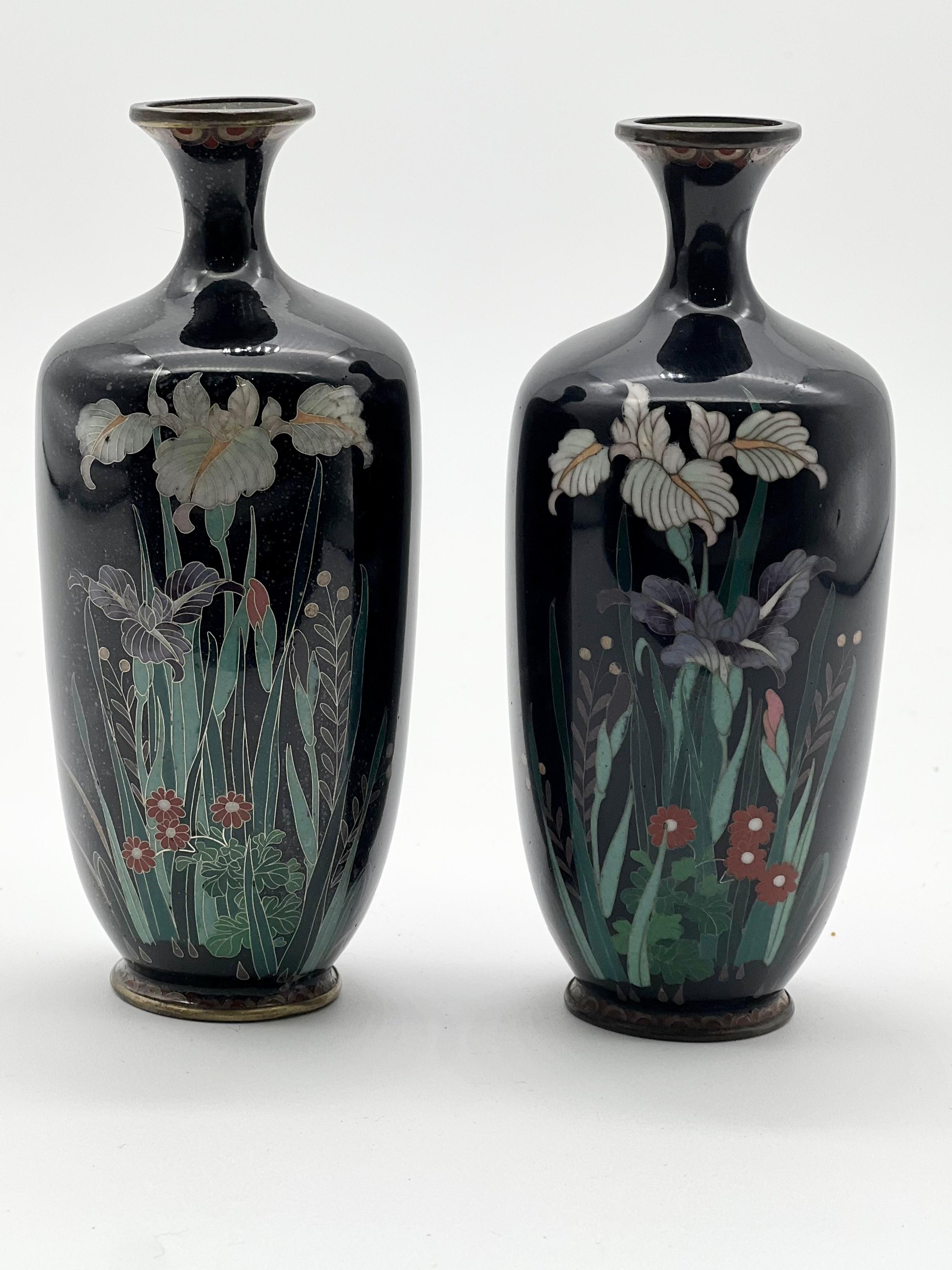 A pair of Japanese Cloisonné enamel ovoid vases by Hayashi Chuzo Kodenji Workshop, Meiji period.

Dark blue ovoid and tapering vases with small flared necks, mirror finish, decorated with fine silver wire and polychrome enamels with blooming iris
