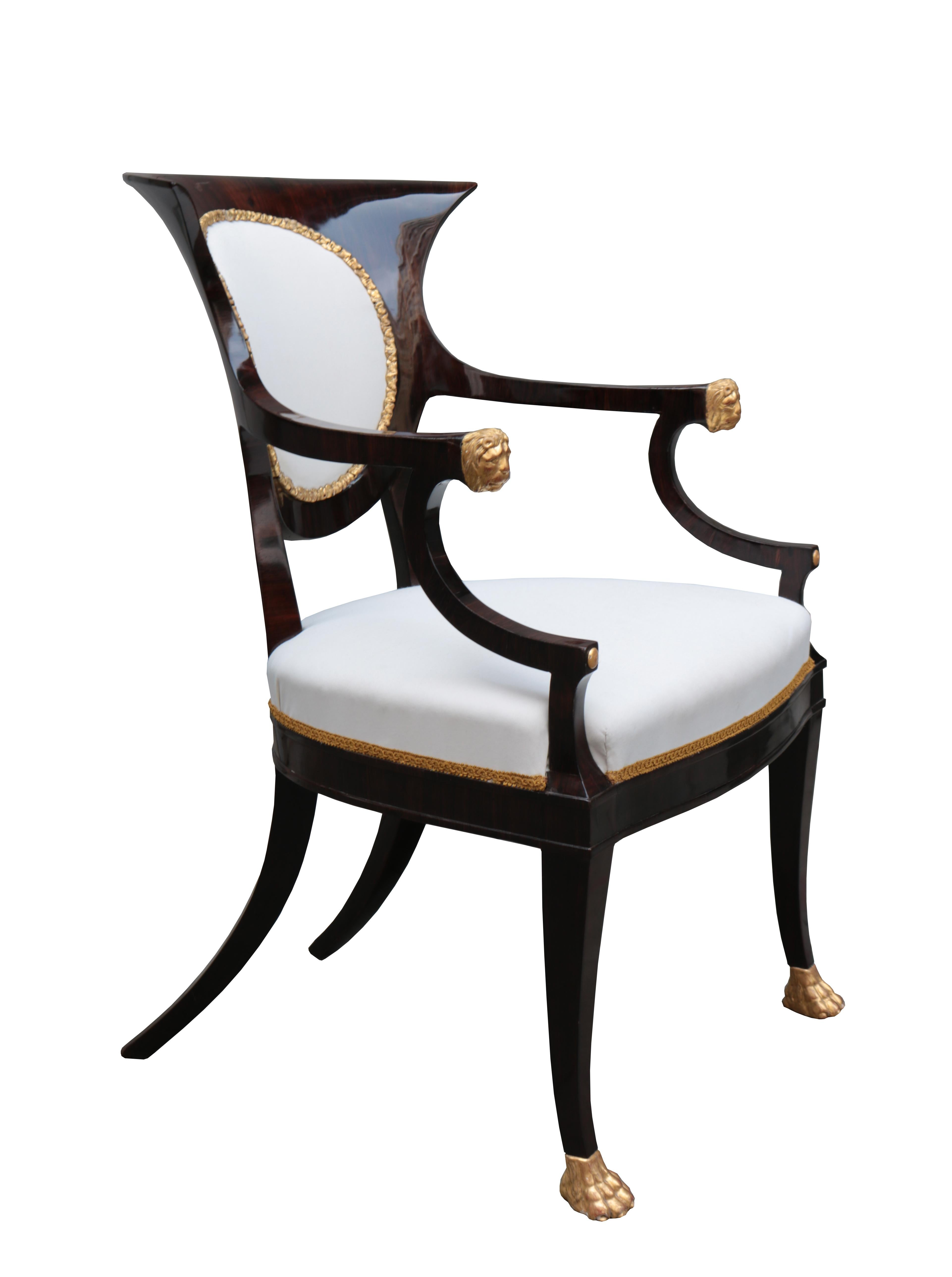 A fine pair of neoclassical armchairs.
Rosewood with fine giltwood carved details.