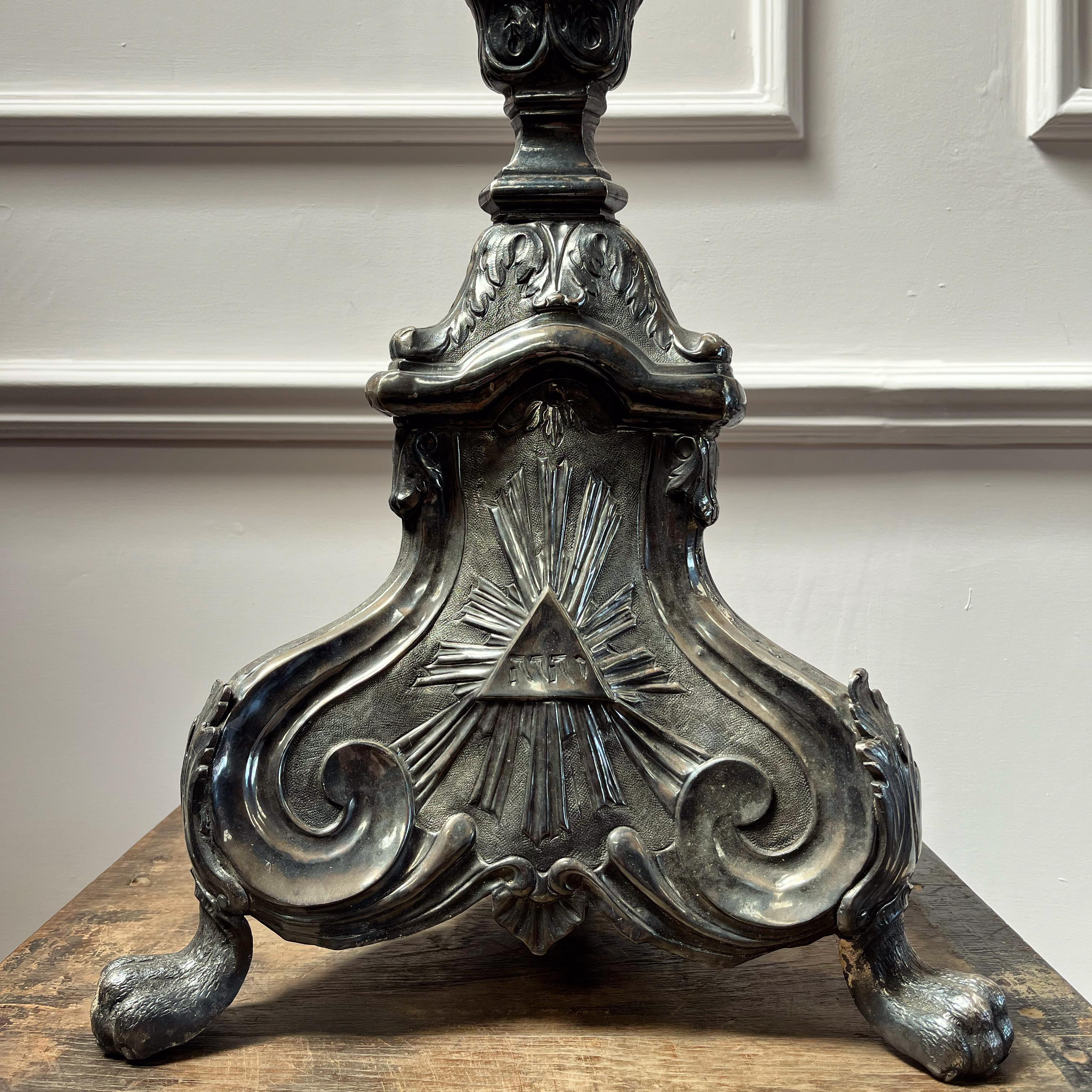 A fine pair of early nineteenth century and possibly earlier repousse candlesticks with tripod bases, exuberant scroll and hairy paw feet, now as lamps.