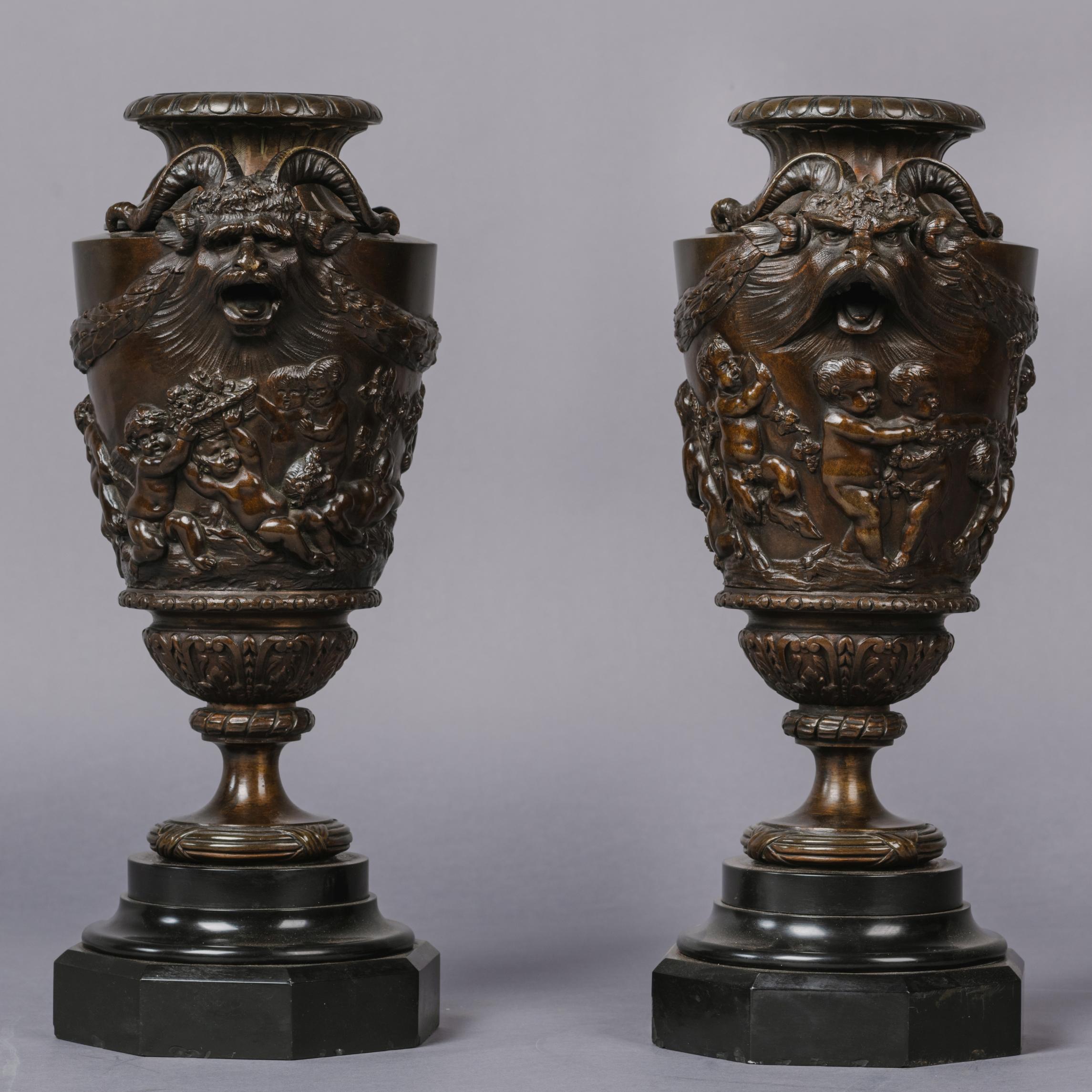 A fine pair of patinated bronze bacchanalian vases, after Clodion.

Cast after the design by Clodion, the vases are modelled with masks depicting chimerical ibex flanked by laurel swags, above a finely carved reliefs of young Bacchanals at play.