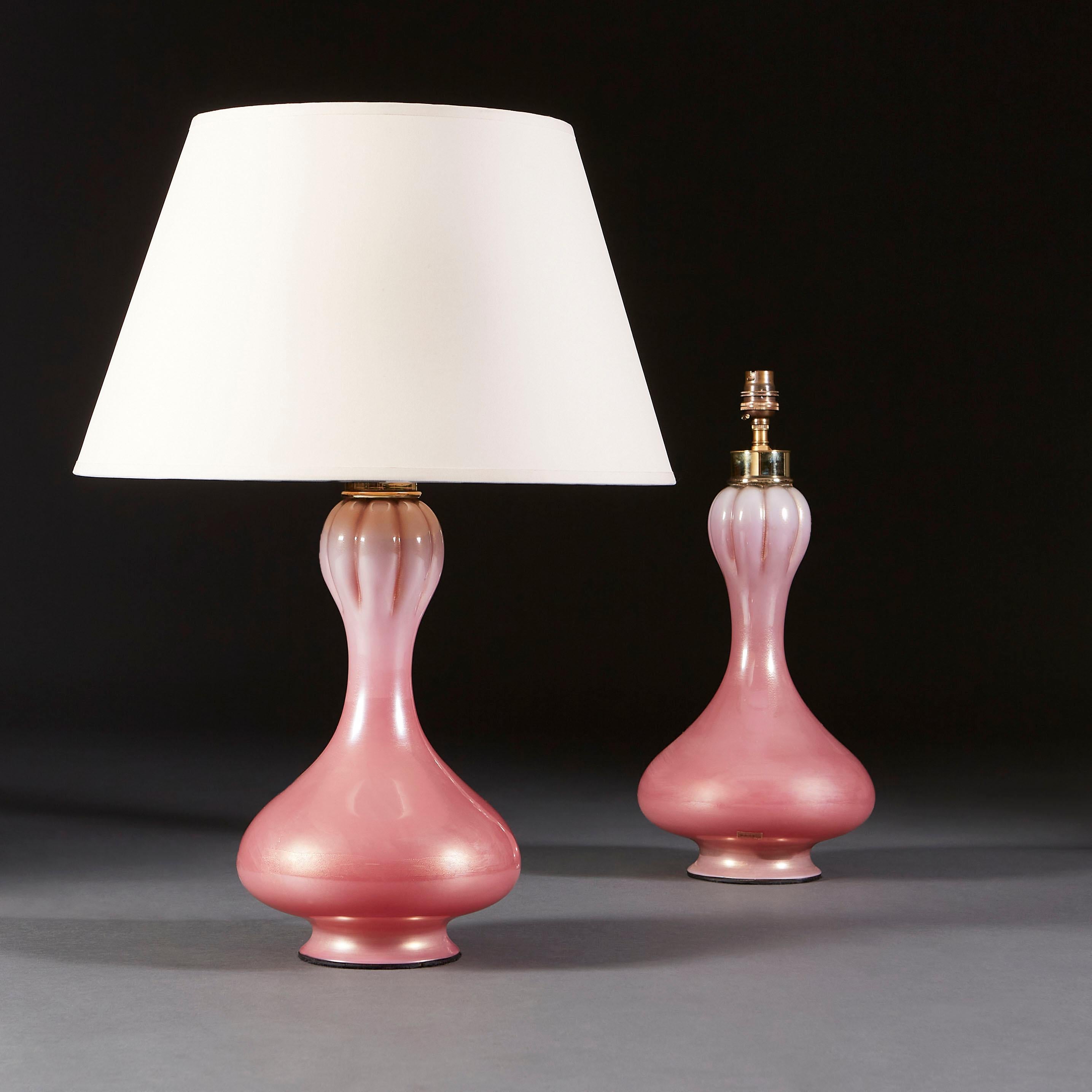 A fine pair of pink Seguso lamps of organic form, with a bulbous base and fluting detail towards the neck of the lamp. The pair of lamps are also stamped with Seguso stickers of authenticity.

Seguso glass is the epitome of luxury glassware, known