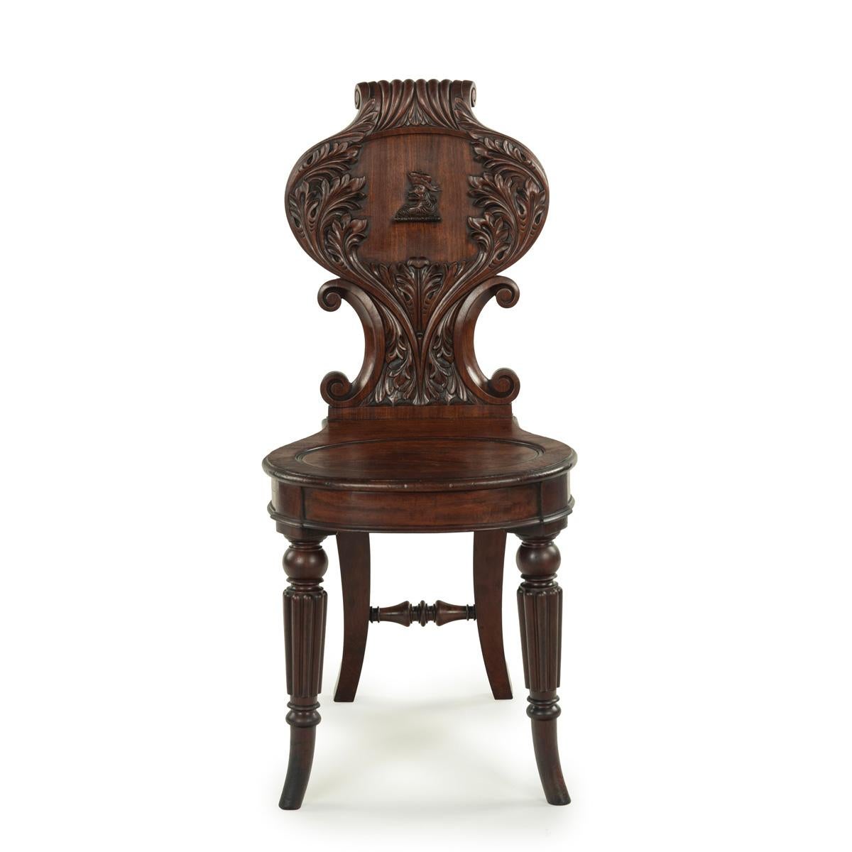 English A fine pair of Regency mahogany armorial hall chairs attributed Gillows