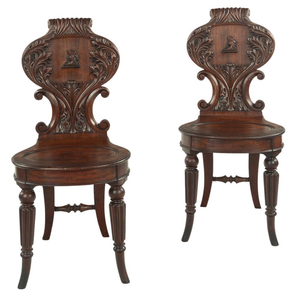 A fine pair of Regency mahogany armorial hall chairs attributed Gillows For Sale
