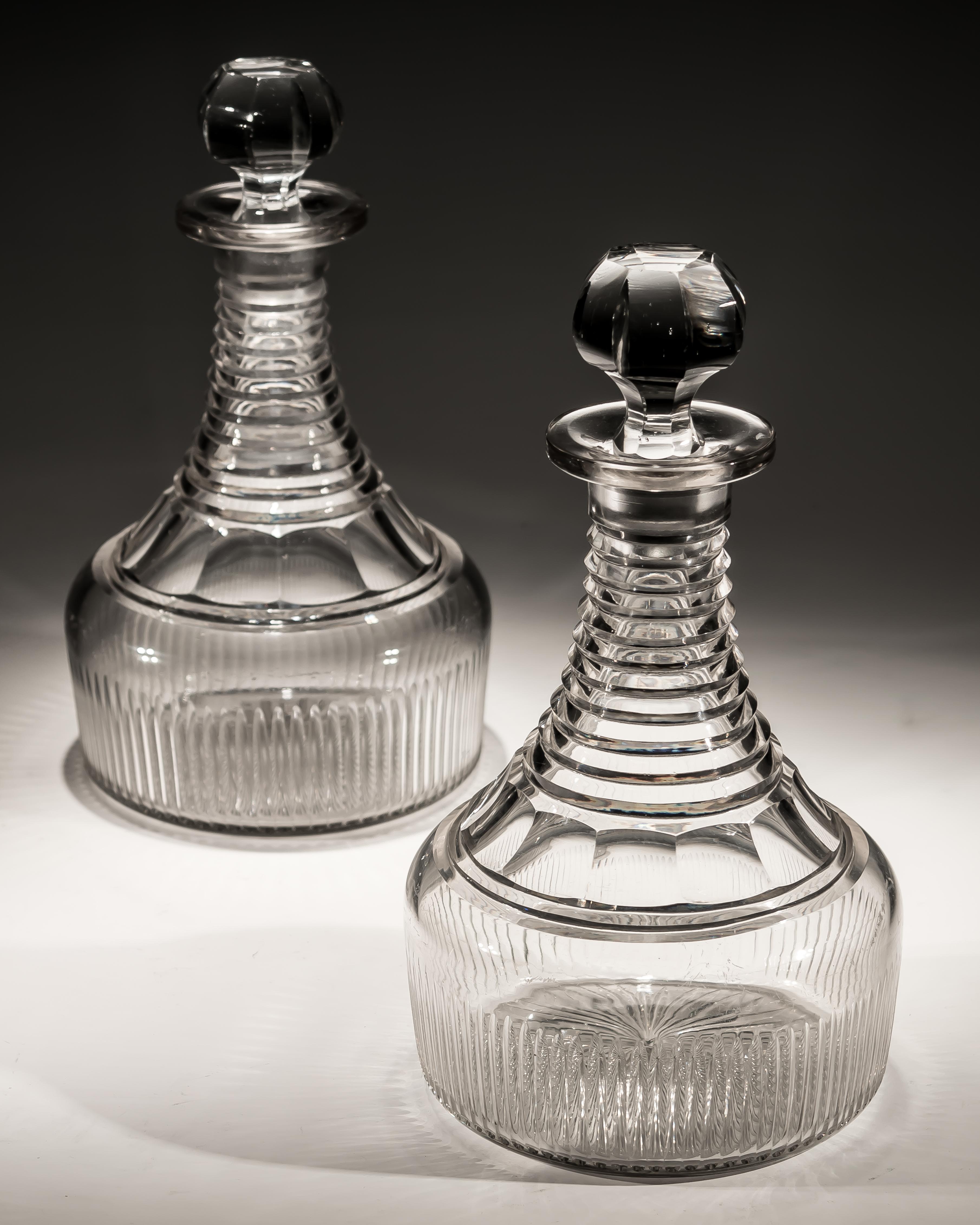 A fine pair of Regency step and flute cut semi ships decanters.