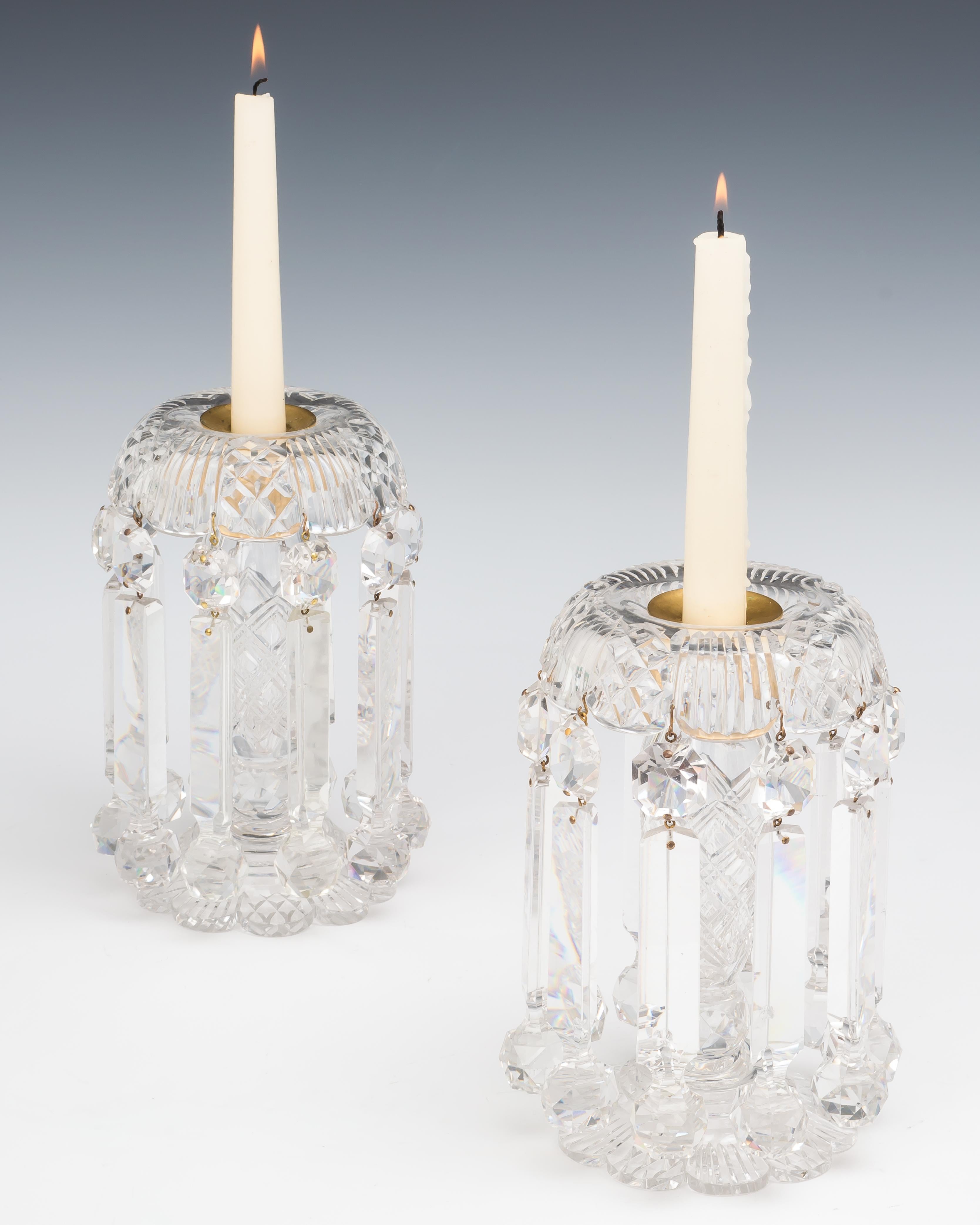 A fine pair of richly cut Victorian glass lustres hung with ball drops.

England, circa 1850.