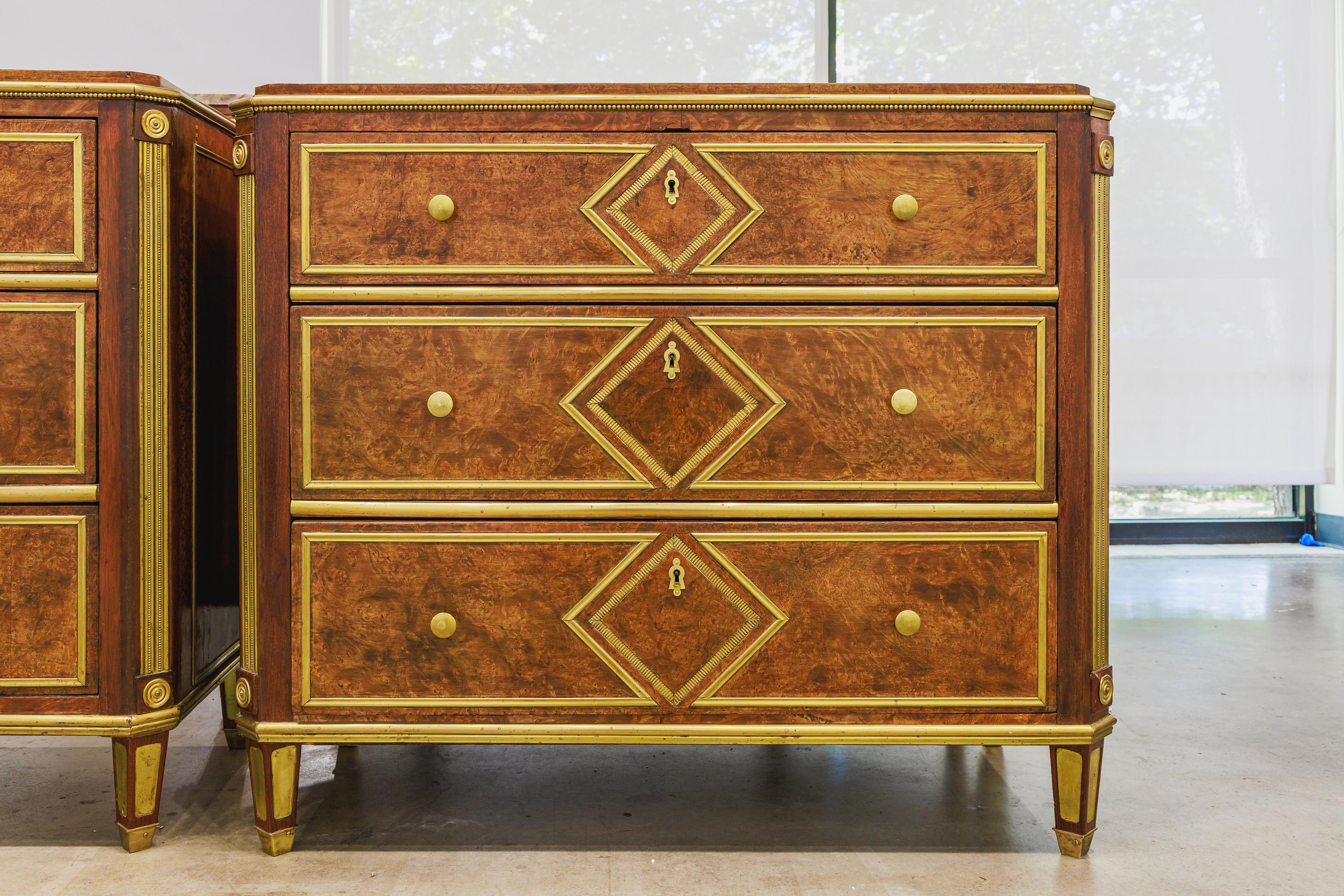 A fine pair of mahogany and brass hand hammered commodes.