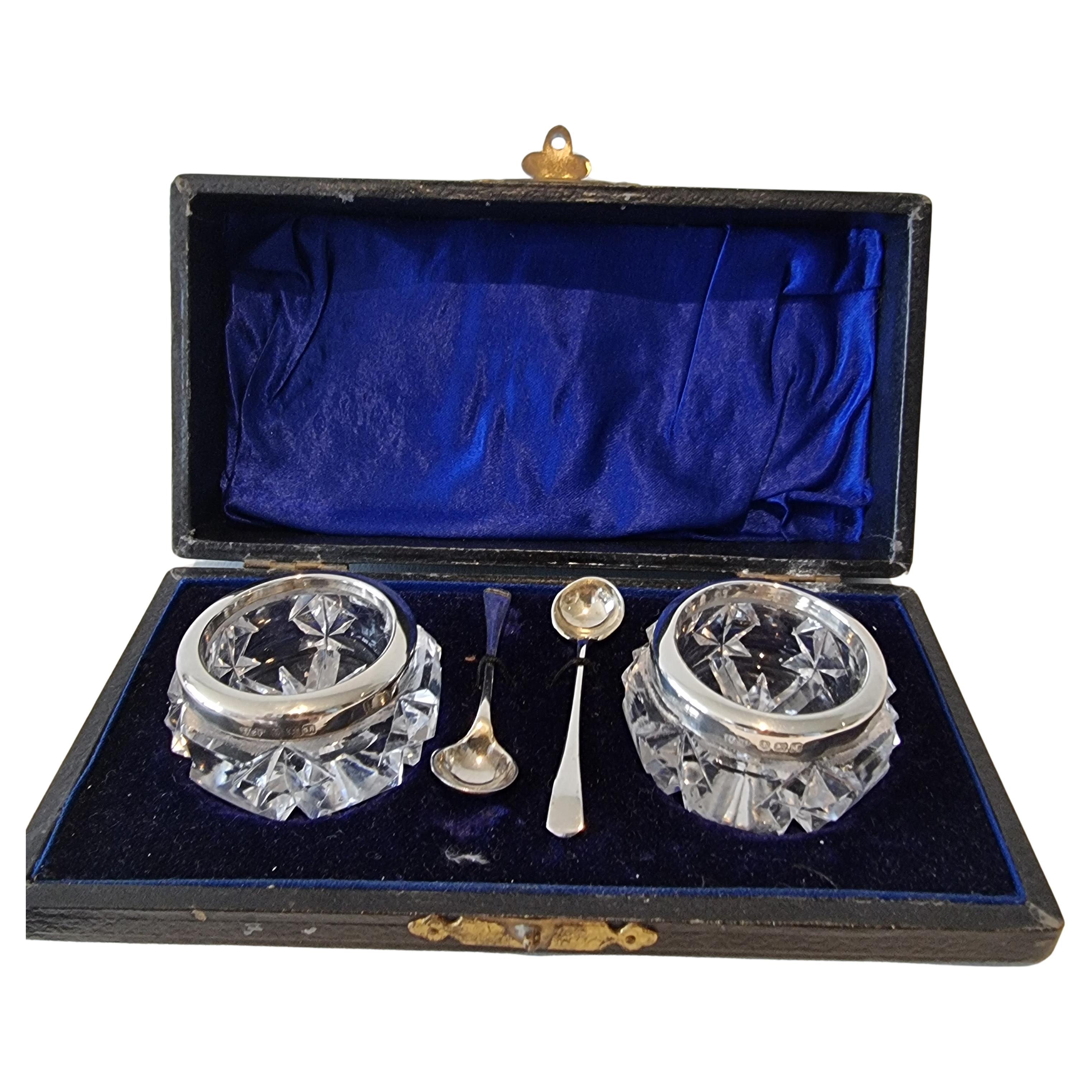 A fine Pair of Silver and Cut Glass Salt and Pepper Pots with spoons in original For Sale
