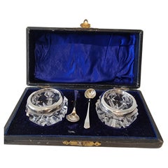 A fine Pair of Silver and Cut Glass Salt and Pepper Pots with spoons in original