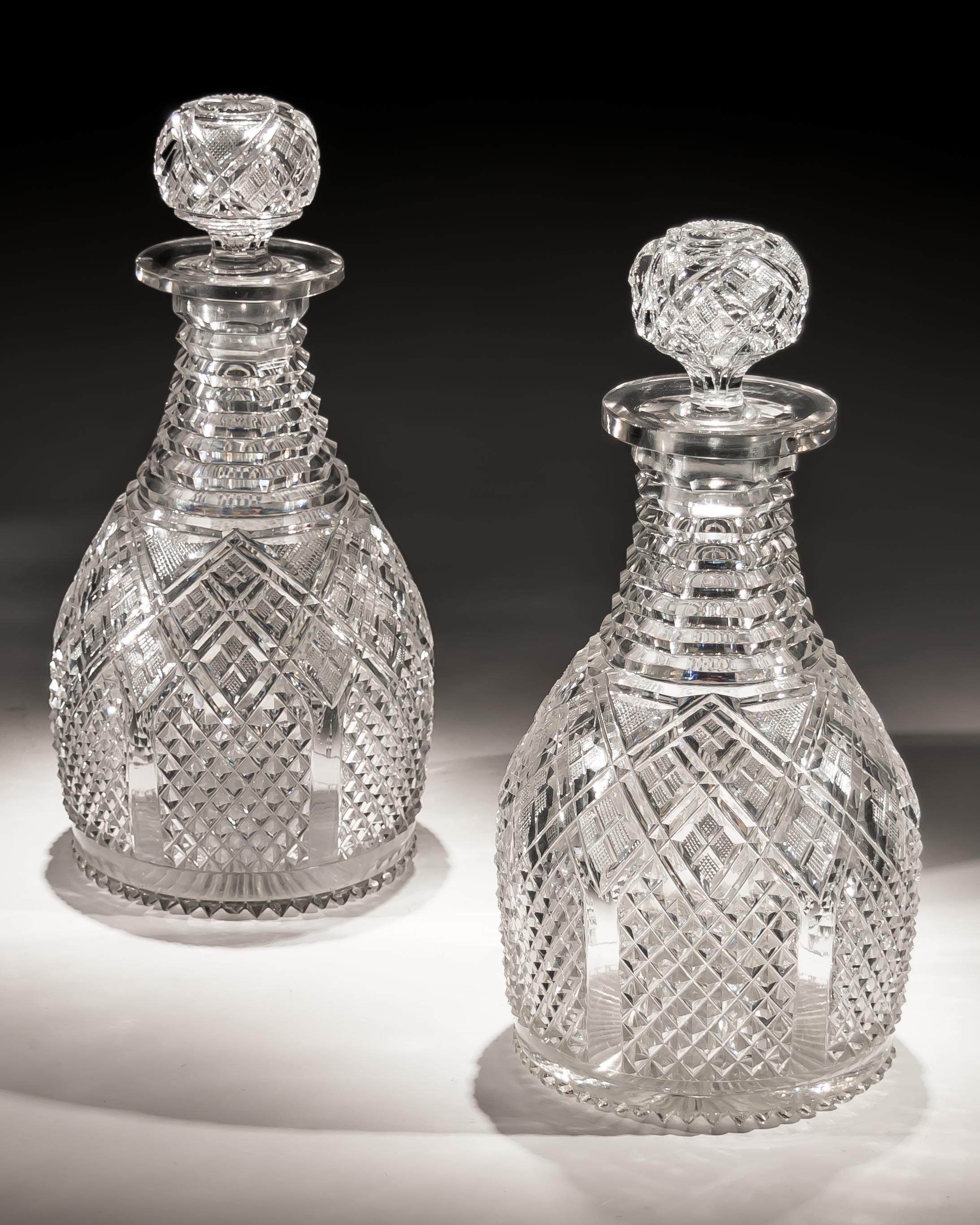 A fine pair of step and diamond panelled cut glass magnum regency decanters.