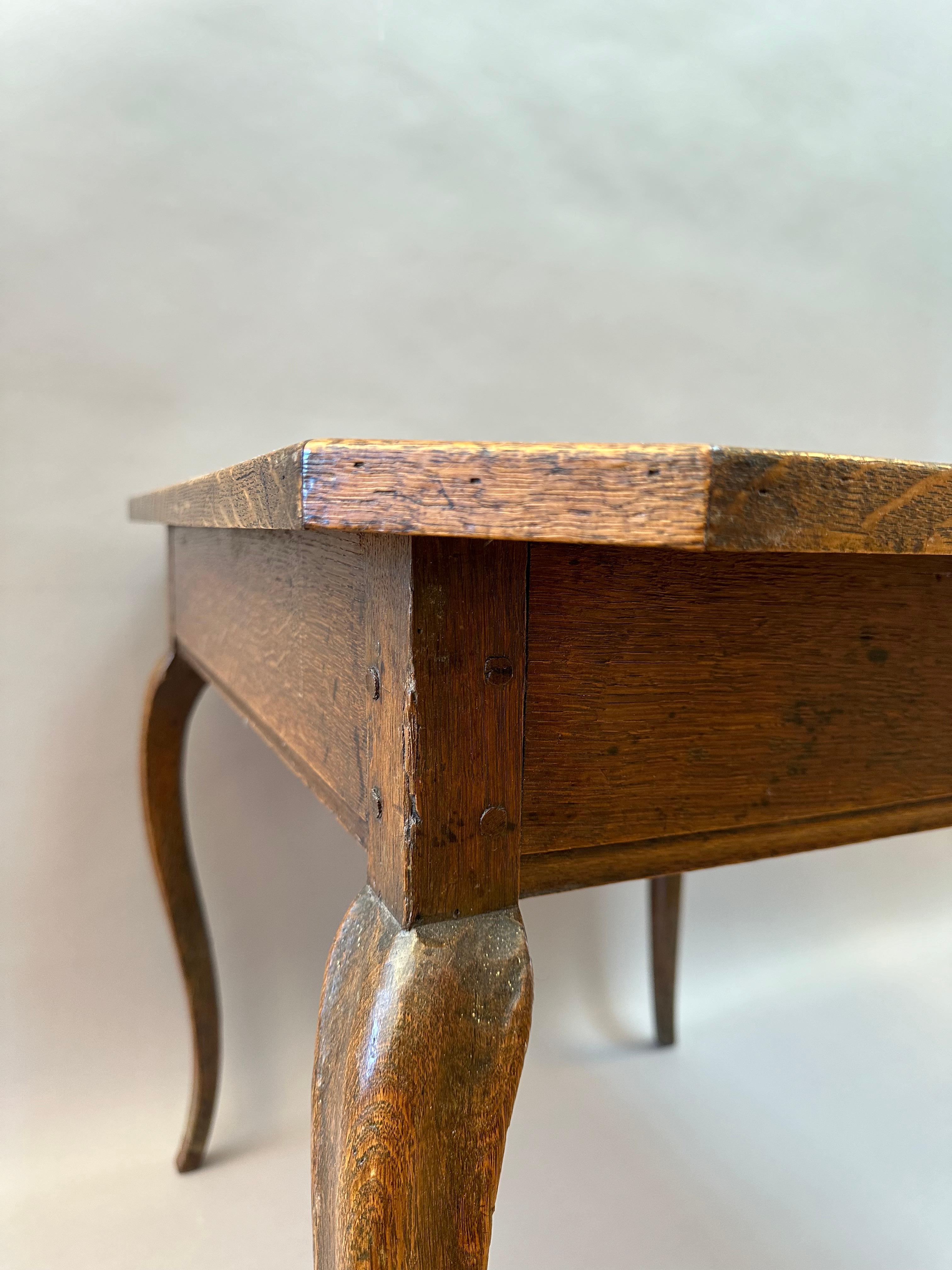 A fine quality 18th century French Provincial games table. Made of richly colored oak with finely shaped cabriole legs, and tooled leather top.  Made in Provence, circa 1780.