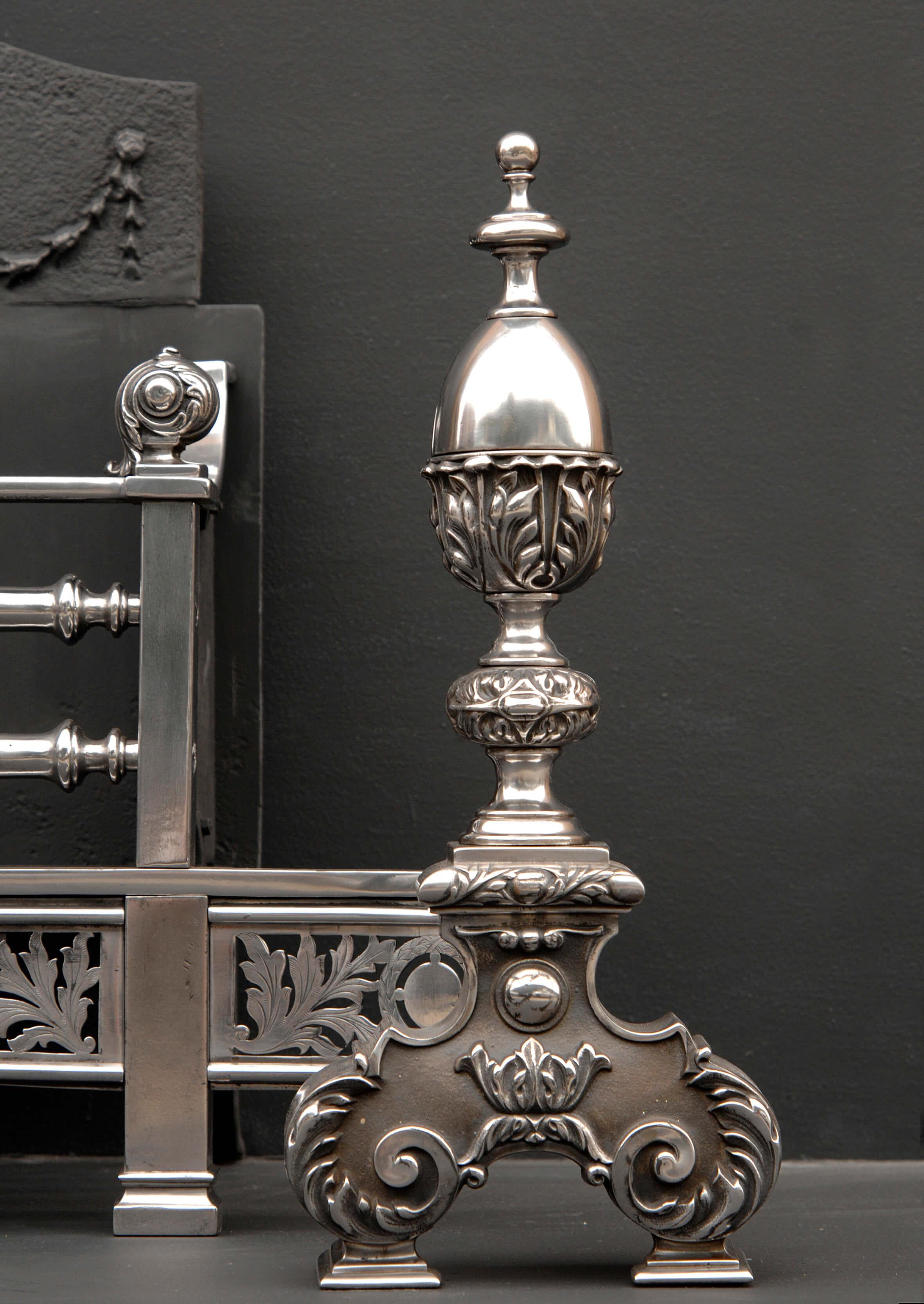 A fine quality 19th century English George III style steel firegrate, with engraved leafwork fret, the dogs with scrolled and leaf cast bases, surmounted by finely cast acanthus leaf finials. Urn and swag cast fireback.

Measures; Width at front: