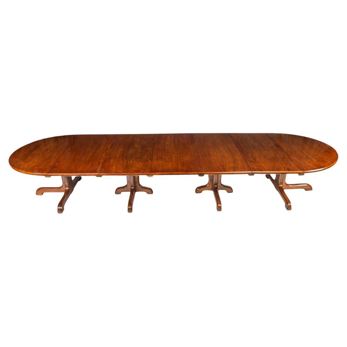 A Fine Quality and Large Four Pillar Brown Oak Extending Dining Table, c.1900 For Sale
