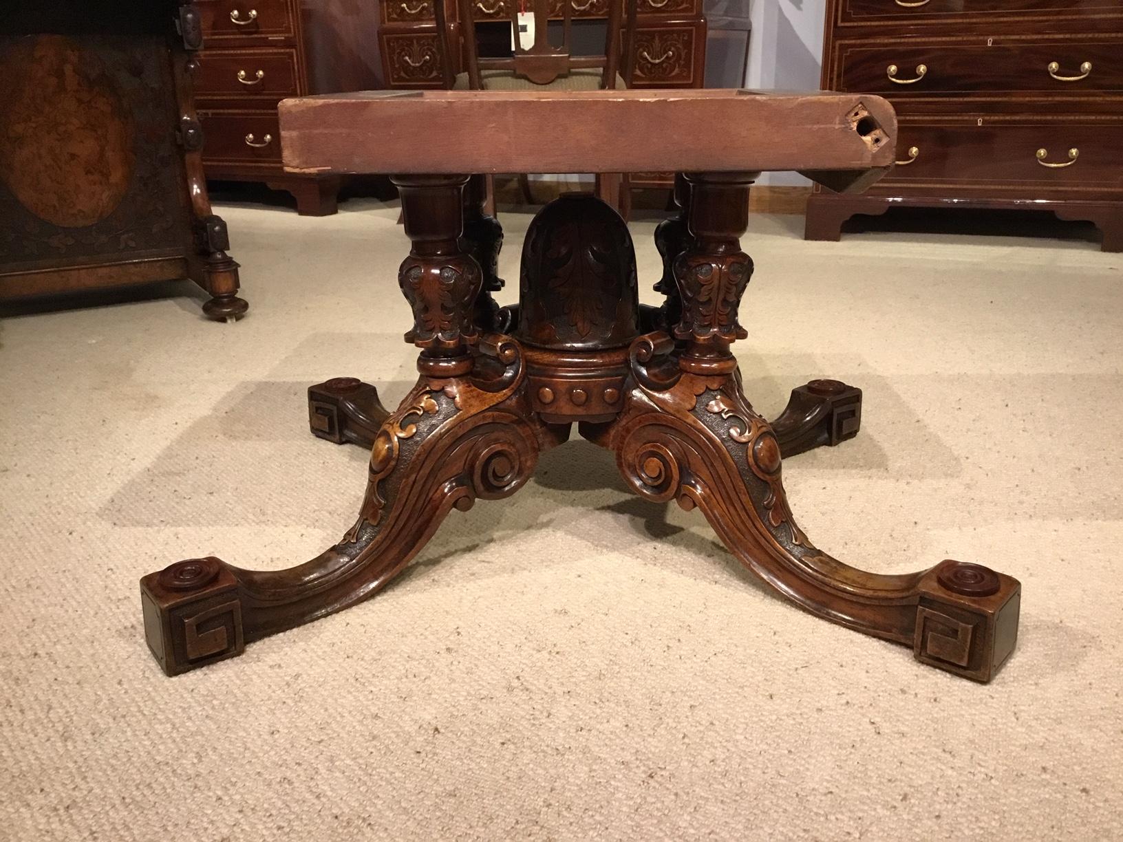 A fine quality burr walnut Victorian period oval antique coffee table. Having an oval top veneered in finely figured burr walnut with four floral marquetry inlaid panels, banded in tulipwood and boxwood and supported on a central lobed column with