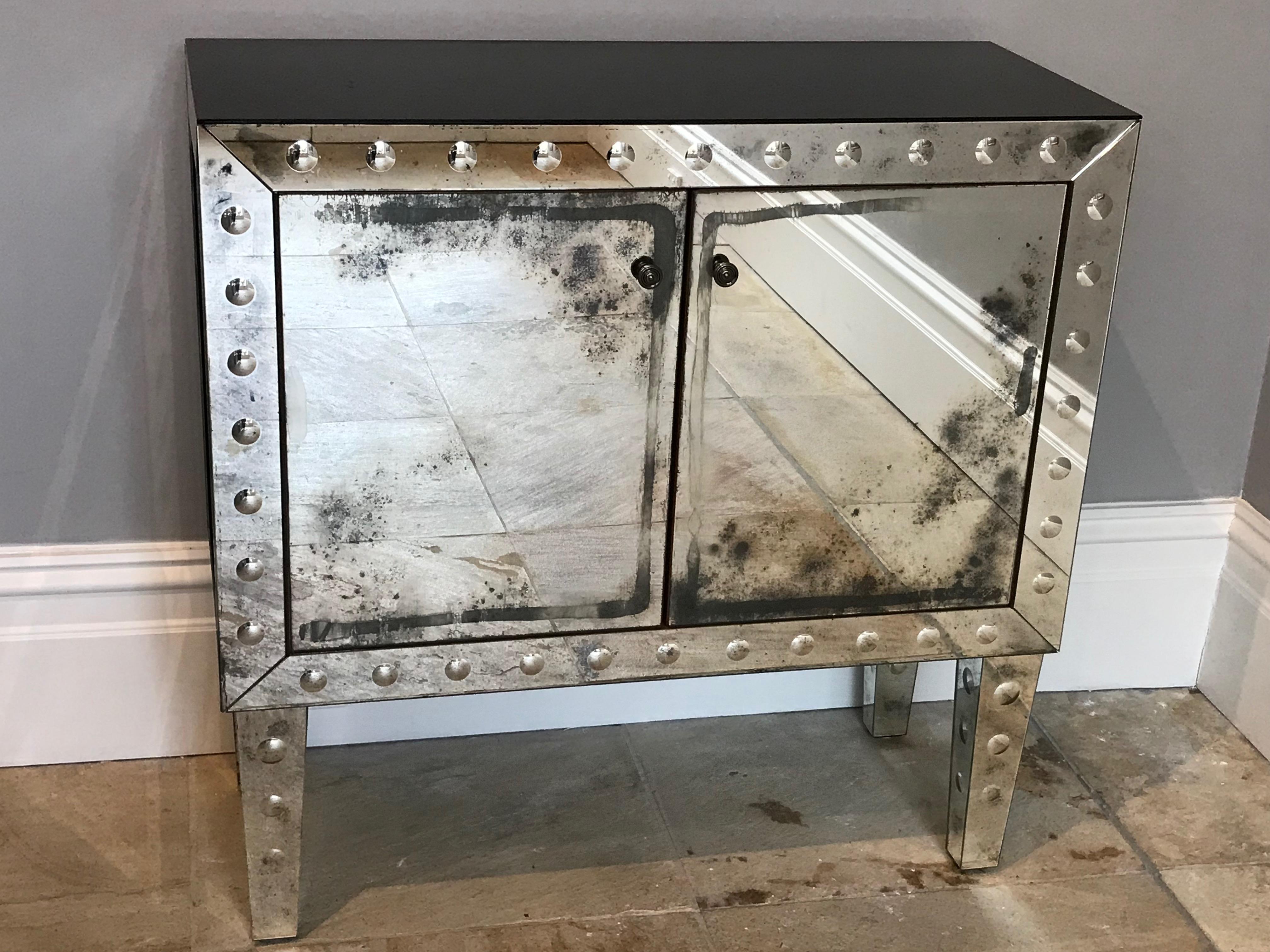 An outstanding quality etched mirrored aged glass cocktail cabinet
French, circa 1960
with black glass sides and top and clear glass shelf inside.

Measures: 90cm high, 91cm wide, 38cm deep

We have never seen a better cocktail cabinet than