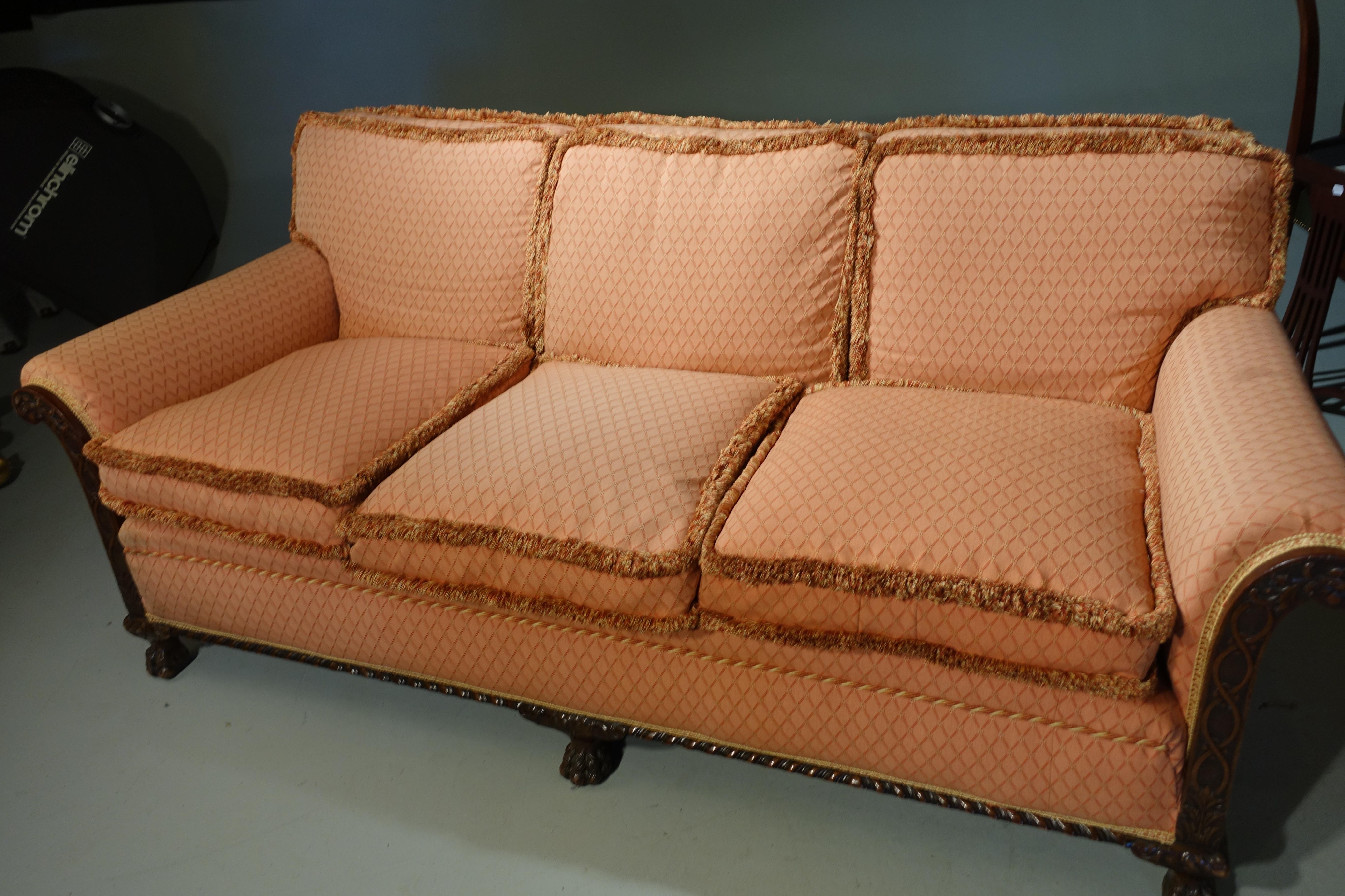 A good 3-seat sofa with well carved façade sections to the front and sides. A gadrooned border. Re upholstered just a few years ago. En Suite with a pair of chairs 

Measure: Seat height 21 inches.