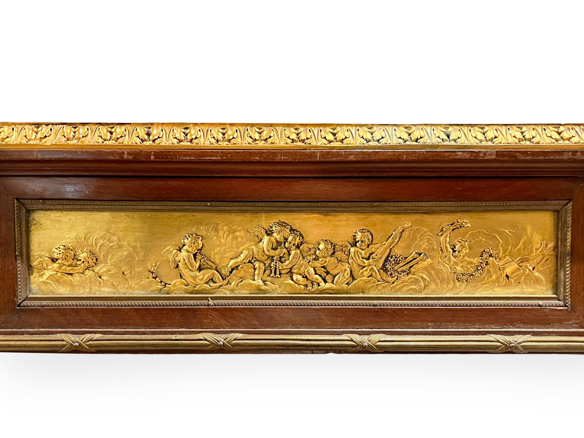 Contains  gilt ornaments and a frieze of putti in heaven on either side. Topped with blind-tooled leather, an inset writing surface. Contains one large drawer that runs the width of the table. 

Maker: Alexandre Chevrié
Origin: French
Date: circa