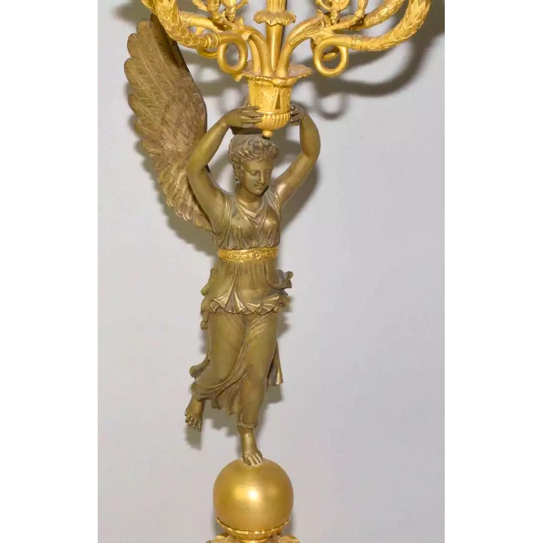 Each winged figure of classical draped women with her foot upon a polished orb.

Origin: French
Date: Circa 1870
Dimension: 30 3/4 in. x 9 3/4 in.