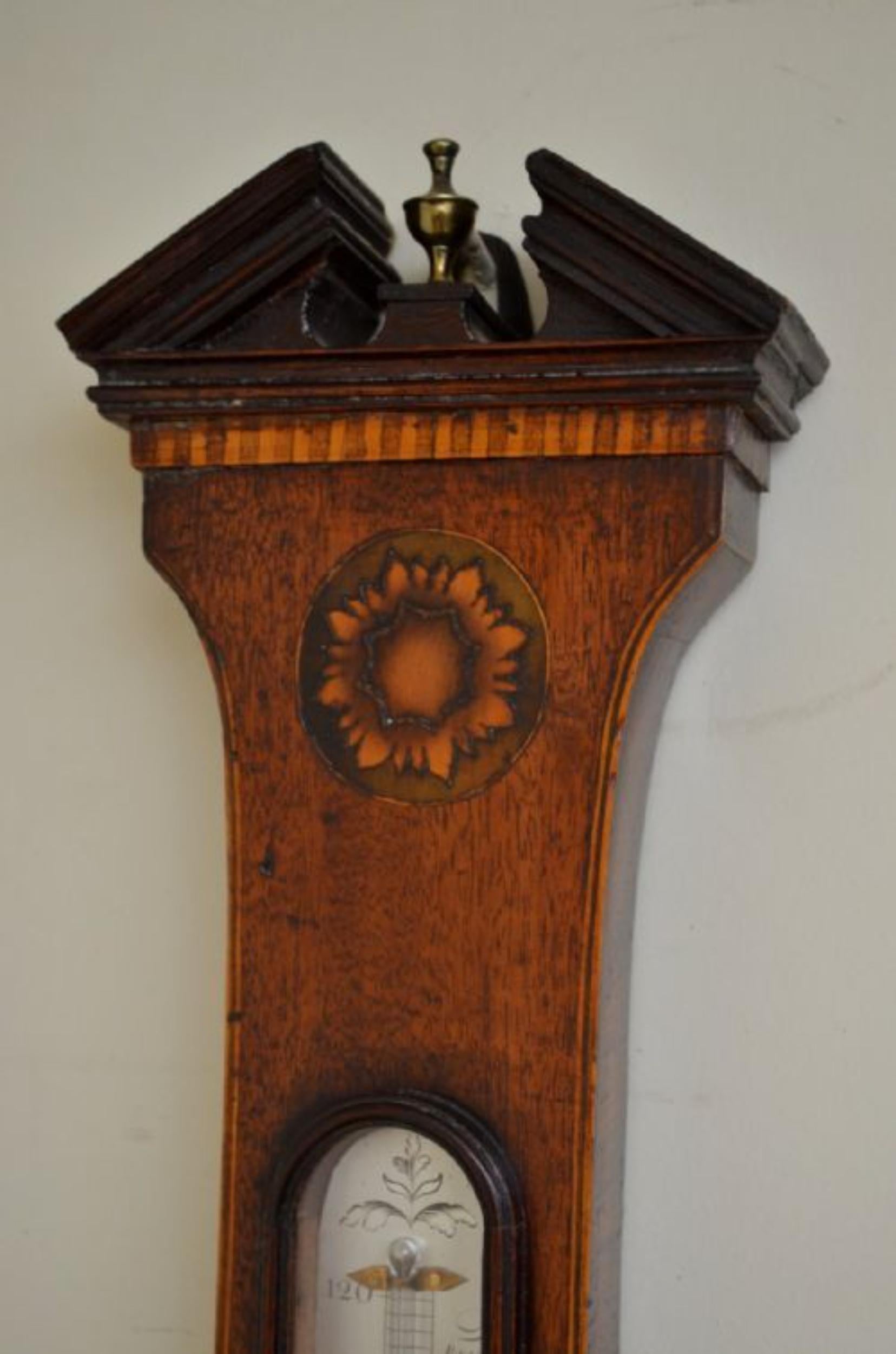 A fine quality, Regency mahogany wheel barometer, the mahogany veneered case with architectural pediment above dentil banding, cross banded edge with triple edge line stringing, inlaid floral paterea and oak and acorn ovals, the 8” dial well