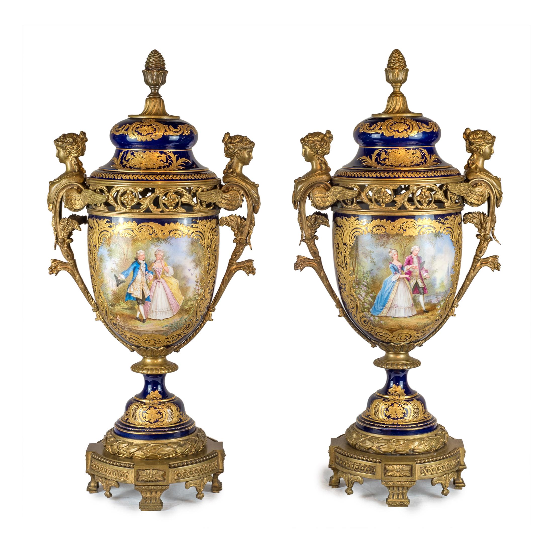 A fine and important Sèvres style bronze mounted and cobalt porcelain with hand painted courting figures in landscapes.

Origin: French
Date: 19th century
Dimension: Centerpiece: 21 in x 23 in, vases: 29 in. x 13 in.