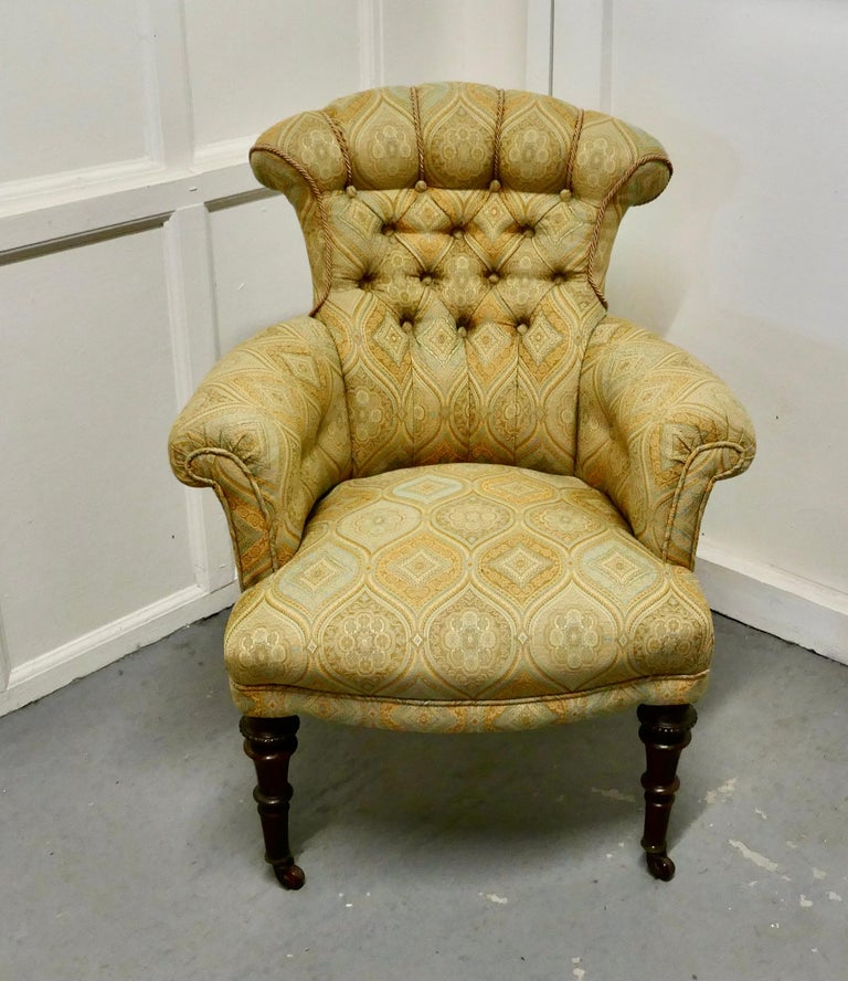 A fine quality Victorian button back arm chair.

The chair has a hard wood frame and has been upholstered in a beautiful silk and linen brocade fabric, it stands on dainty turned legs with casters

This a very comfortable chair and it is in good