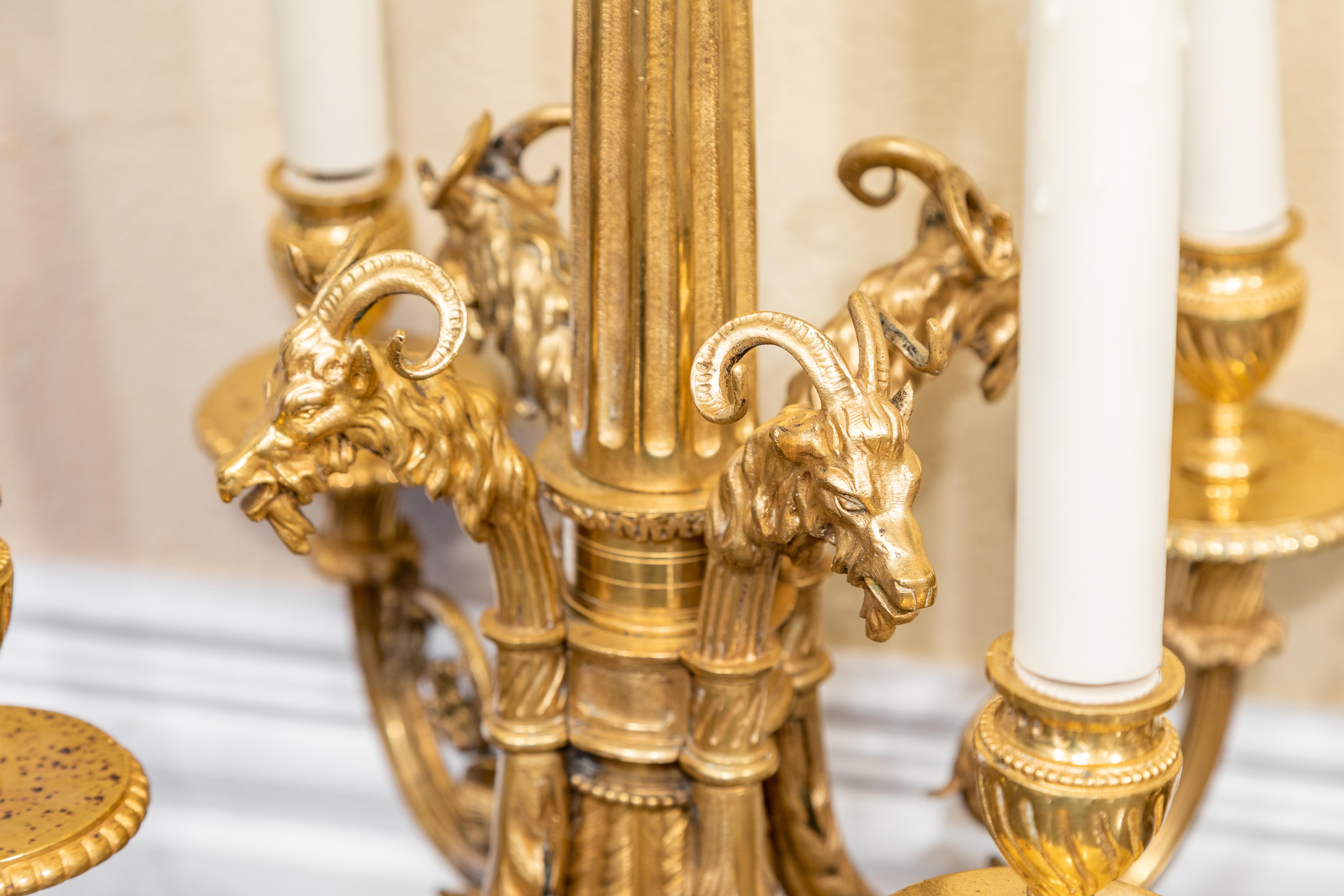 A fine pair of 19th century French Louis XVI gilt bronze rams head designed chandeliers.