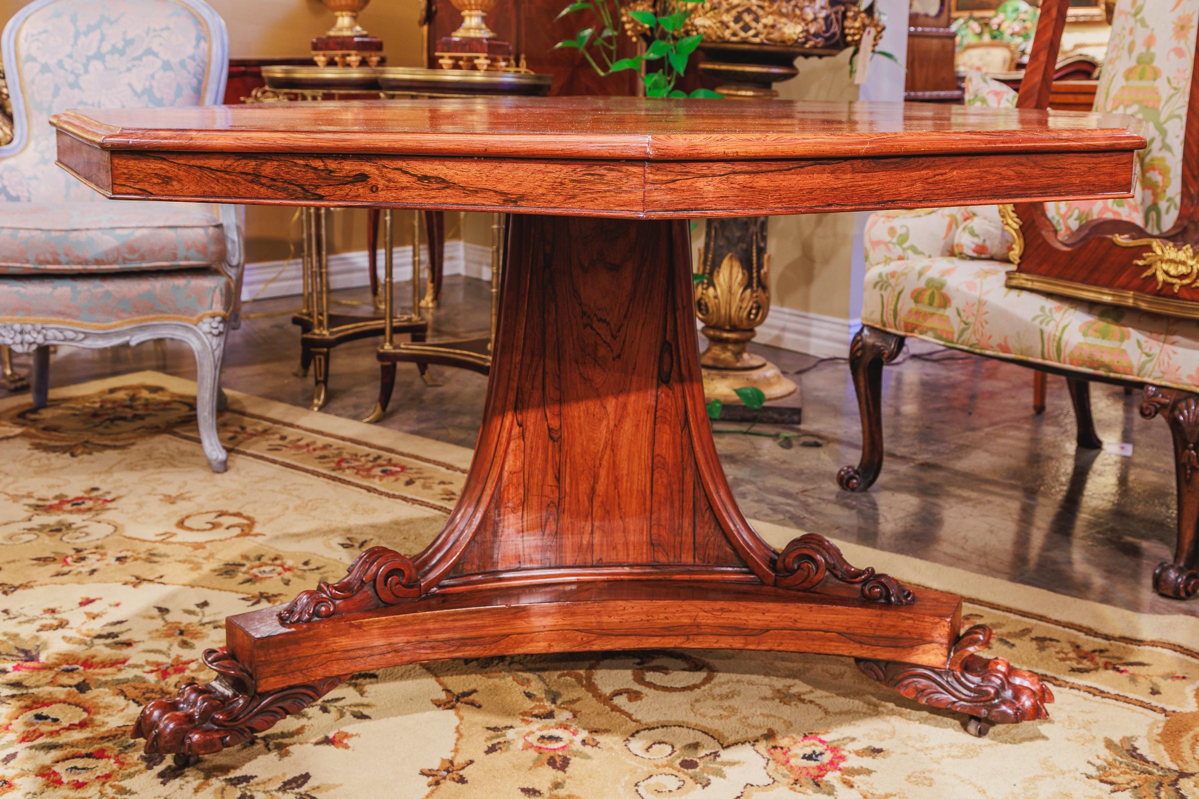 A fine Regency period rosewood octagonal center table, Beautifully hand carved pedestal base with pawed feet.