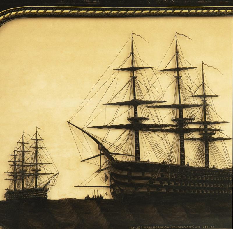 This reverse glass painting shows the silhouettes of three British naval ships of the line within a ropework border, their outlines inside the glass casting shadows on the cream ground behind.  It is in the original bird’s eye maple frame. 