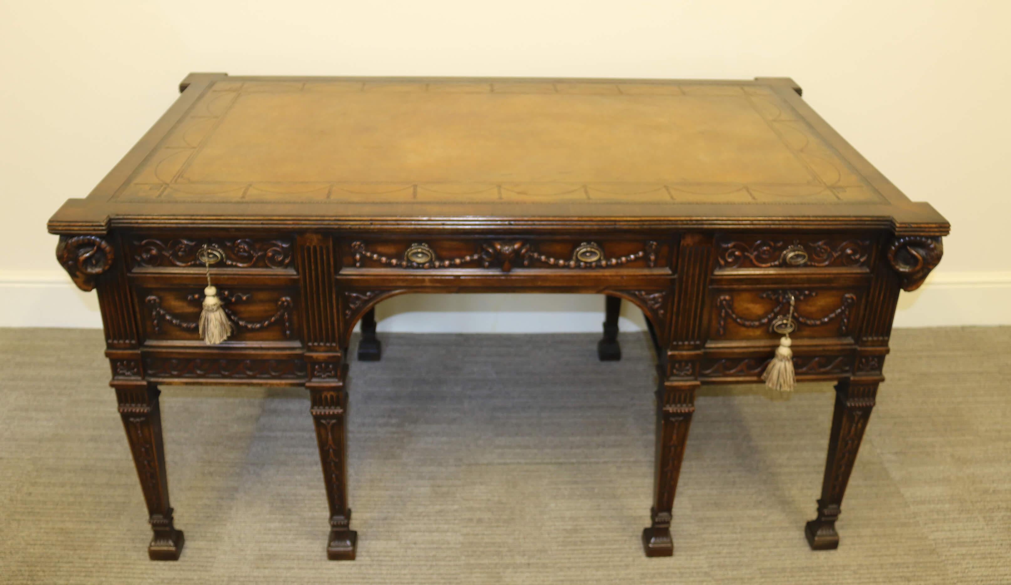 This highly impressive freestanding desk is made in mahogany to an 18th century Robert Adam design. It was made in the late 19th century by the Irish firm of cabinet makers M. Butler of Dublin. It is a very luxurious piece with highly decorative