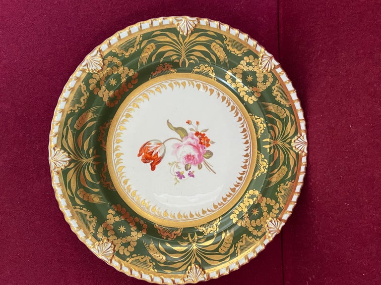 A fine Rockingham porcelain dessert plate c.1826 of Anthemion and gadroon' shape. Finely decorated with a deep green border accentuated with fine gilding. The central reserve decorated with a bouquet of flowers. Marked in red to the
