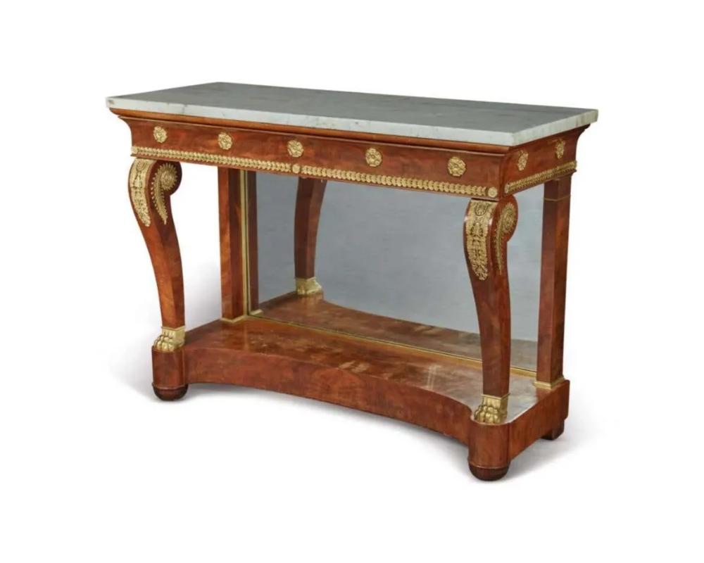 A Fine French Empire Ormolu-Mounted mahogany console table, Circa 1815.

With a white marble top and mirrored glass back. Very high quality and delicate French bronze mounts. Very elegant design.

37? high x 52? wide x 21? deep

Very good