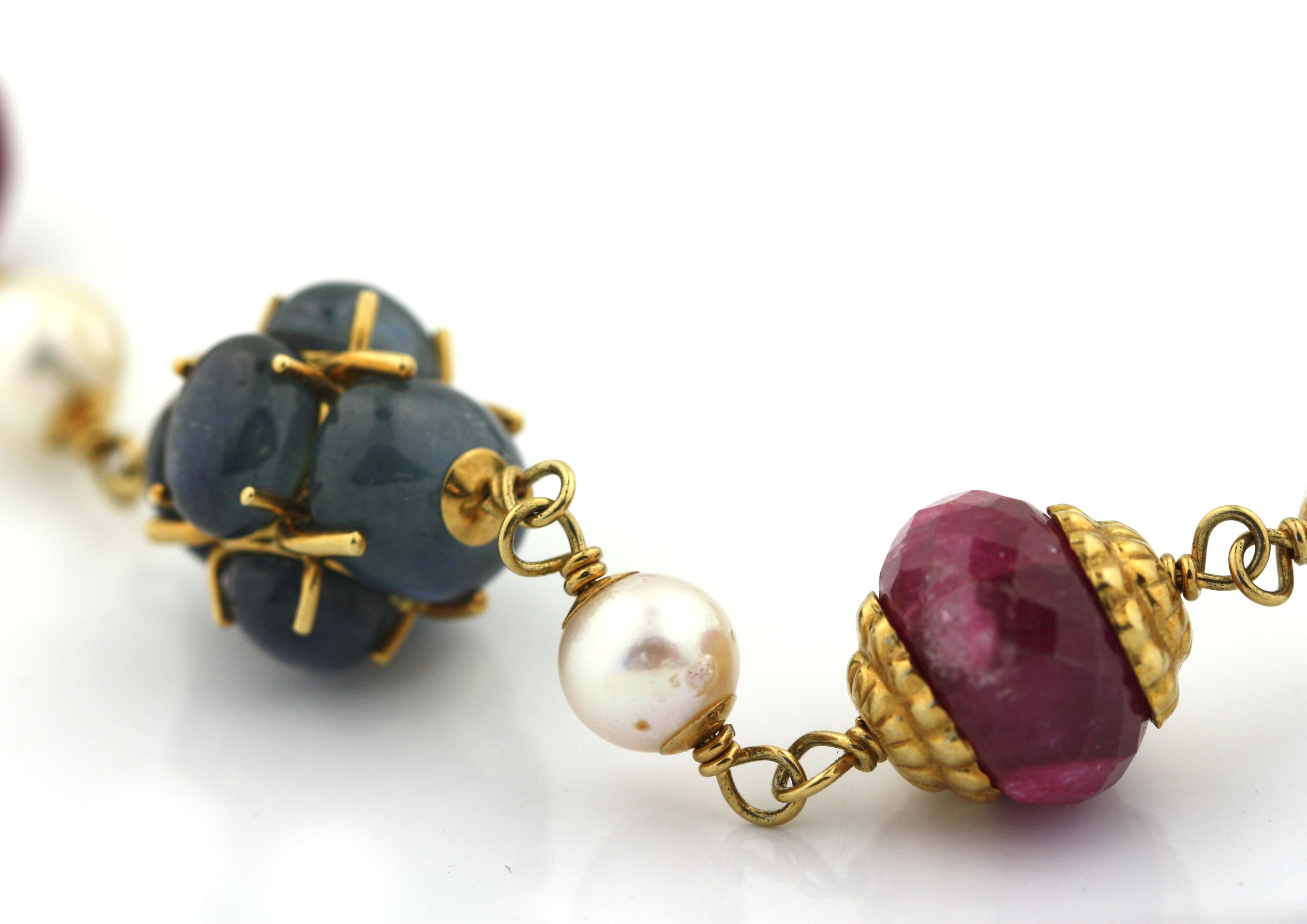 
A Fine Sapphire, Ruby and Pearl Necklace
Spanish Renaissance inspired.
The necklace composed of carved rubies, cabochon sapphires, pearls and foliate round gold caps, mounted in 18 karat yellow gold,
length 17 inches,
total weight 93.3