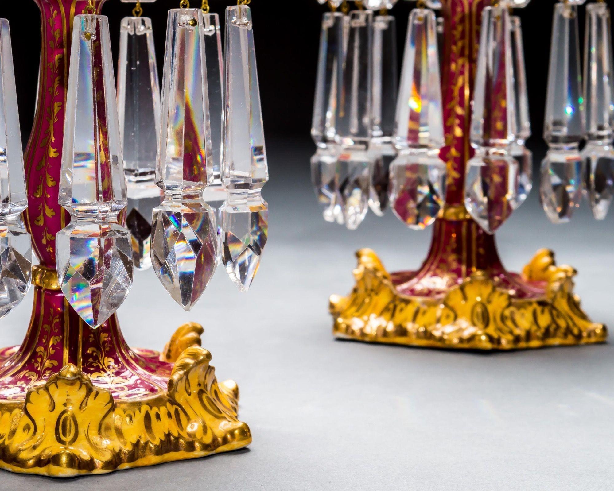 An exceptionally fine set of four crimson red porcelain candlesticks with fine gilt decoration hung with most unusual spade drops.