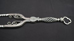 A fine Set of Polished Wrought-Iron Fire Tools with Clover Leaf