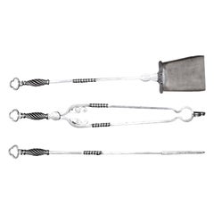A fine Set of Polished Wrought-Iron Fire Tools with Clover Leaf