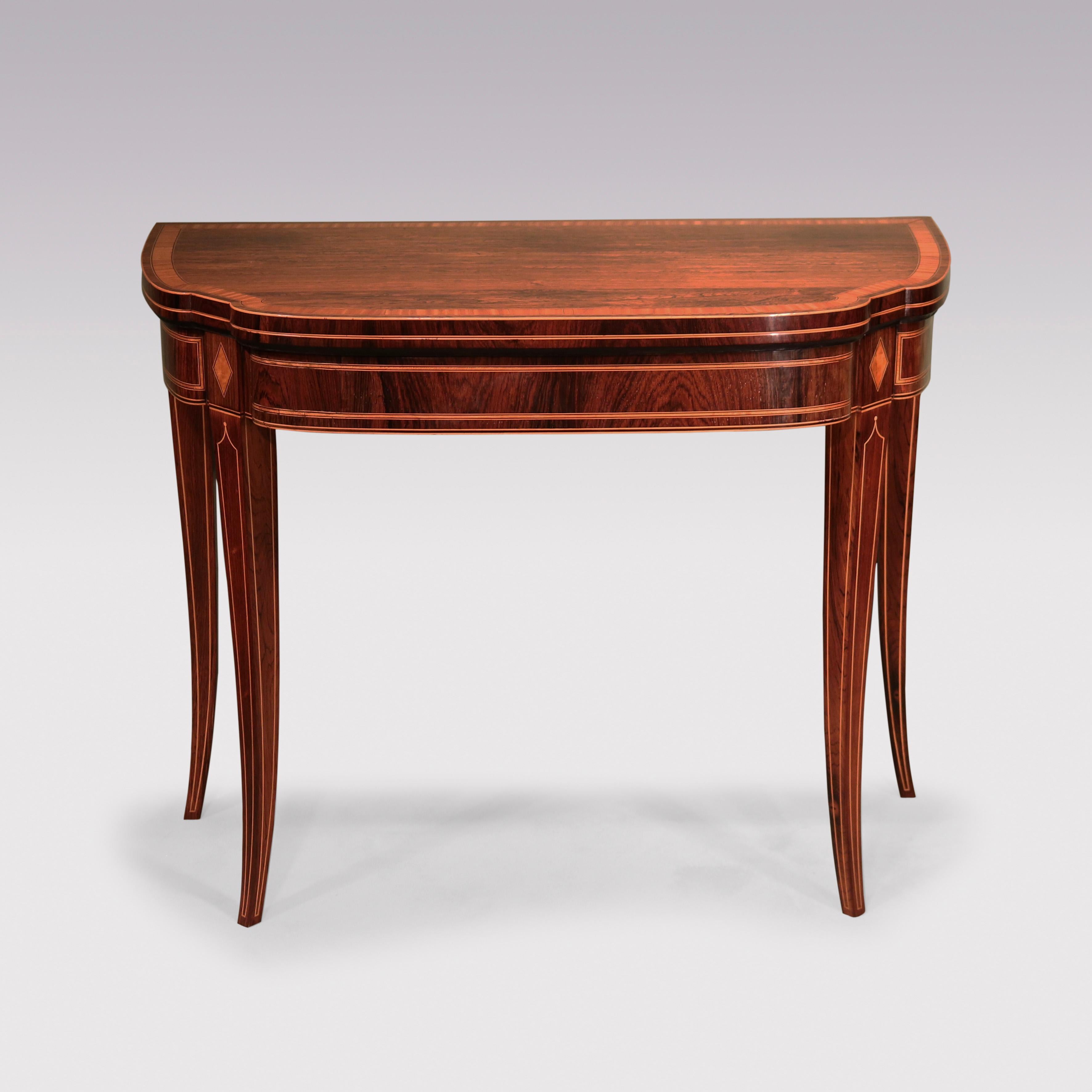 A fine quality Sheraton period rosewood Card Table, boxwood & ebony strung throughout, having unusual shaped satinwood crossbanded top above panelled frieze with diamond inlays supported on square tapering sabre legs.