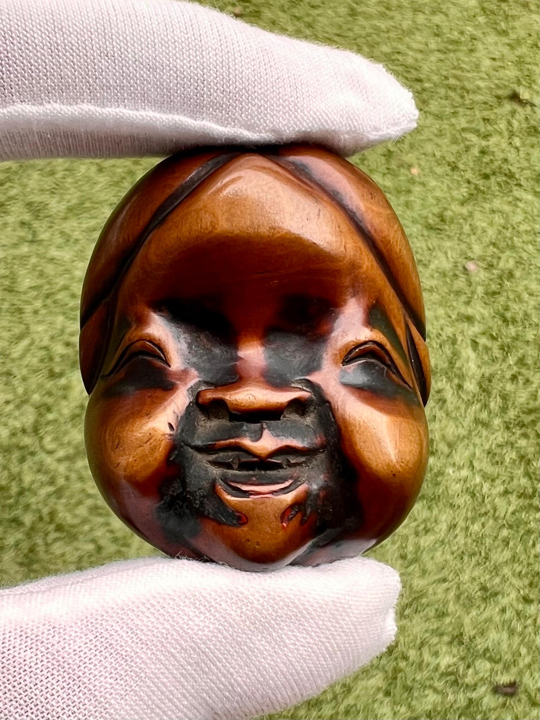 
Masque Shunga Netsuke d'Okame avec sculpture érotique cachée

Japon, période Edo à Meiji (vers 1850-1900)

Matériau : Buis teinté



Un charmant netsuke finement sculpté représentant le visage souriant d'Okame (Otafuku), la déesse traditionnelle de