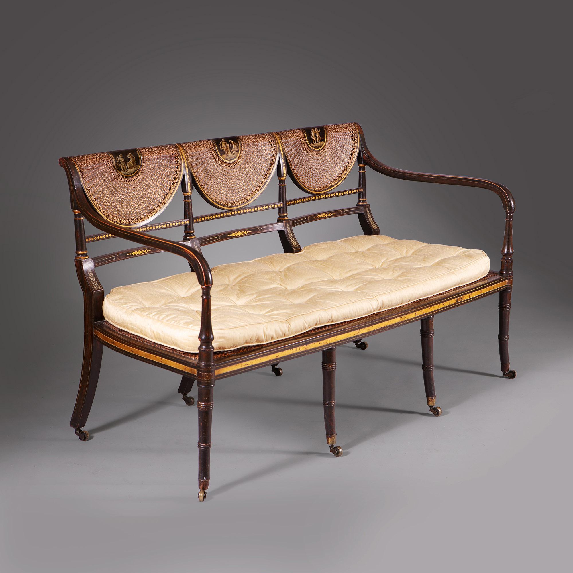 A particularly fine English Thomas Sheraton period simulated rosewood and gilt decorated settee. Circa 1800 England.

The finely decorated settee is in the most remarkable original condition, including all of the original decoration, gilding, cane