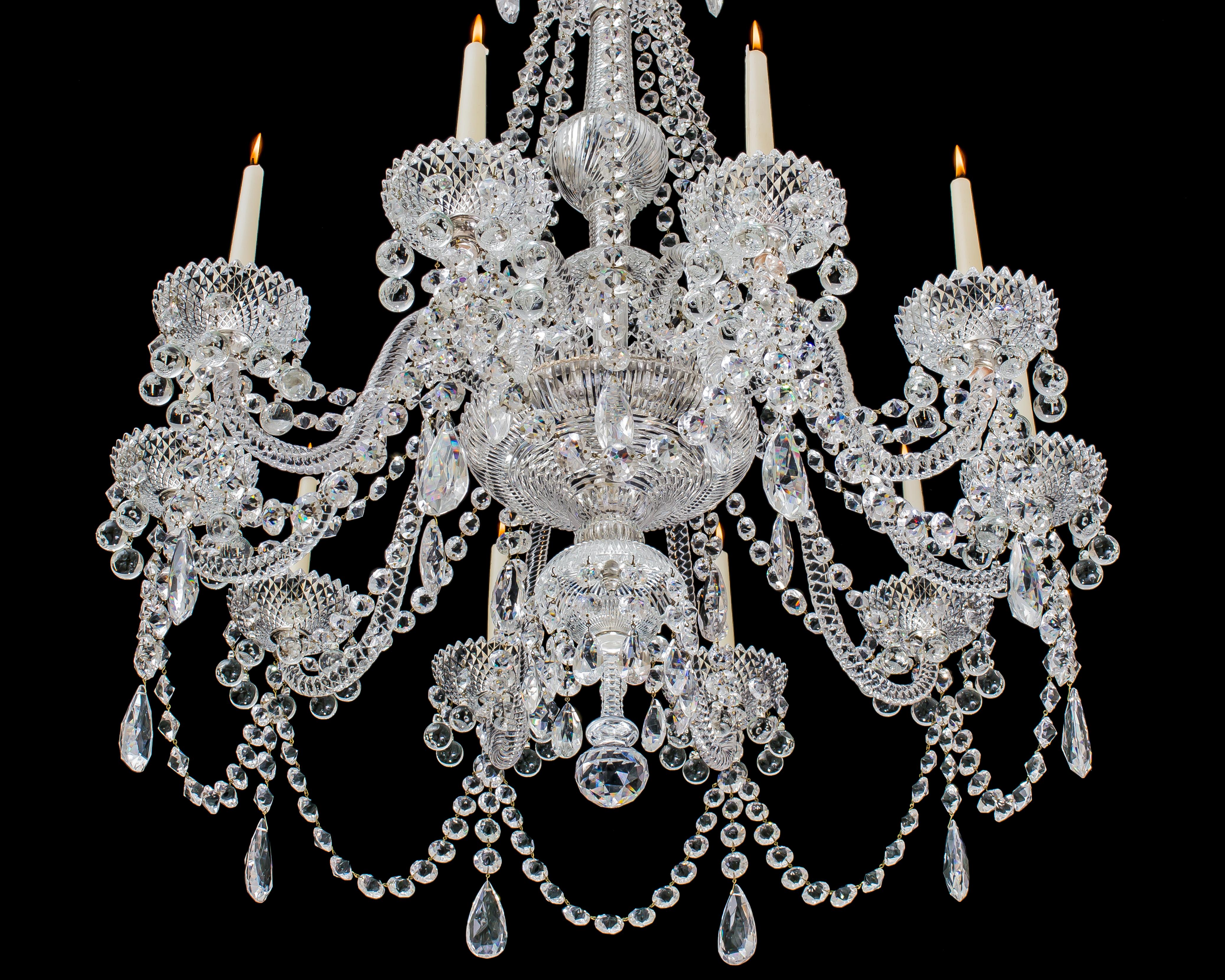 A fine ten-light cut-glass chandelier by Perry & Co the main baluster stem with large top canopy and drop hung stem pans cascading to ten rope twist candle arms these supporting drop hung drip pans impressed with diamonds, the mitre cut receiver