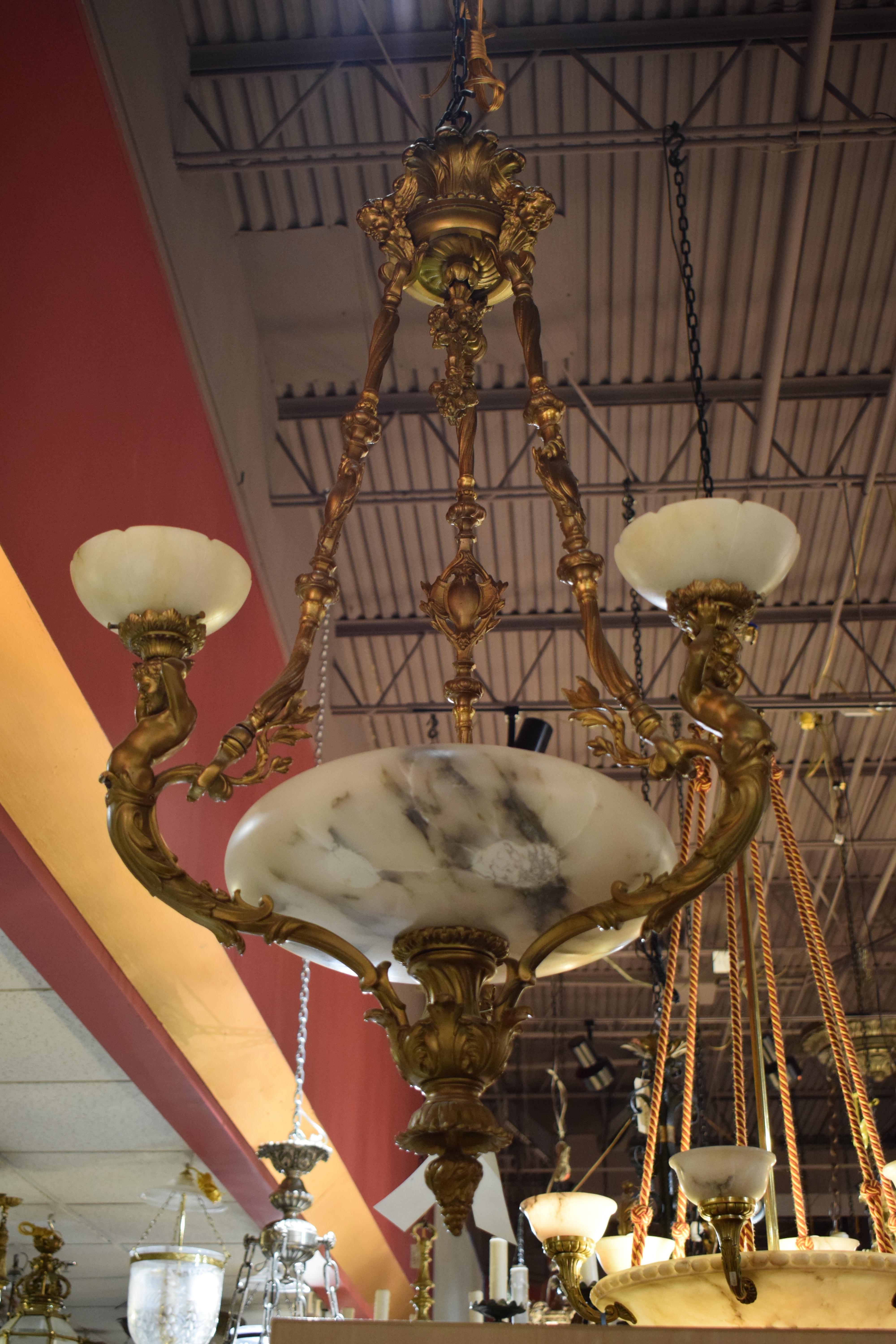 A fine & unusual gilt bronze & alabaster chandelier. 6 lights ( 3 inside & 3 outside). Bowl as is.
Dimensions: height 42